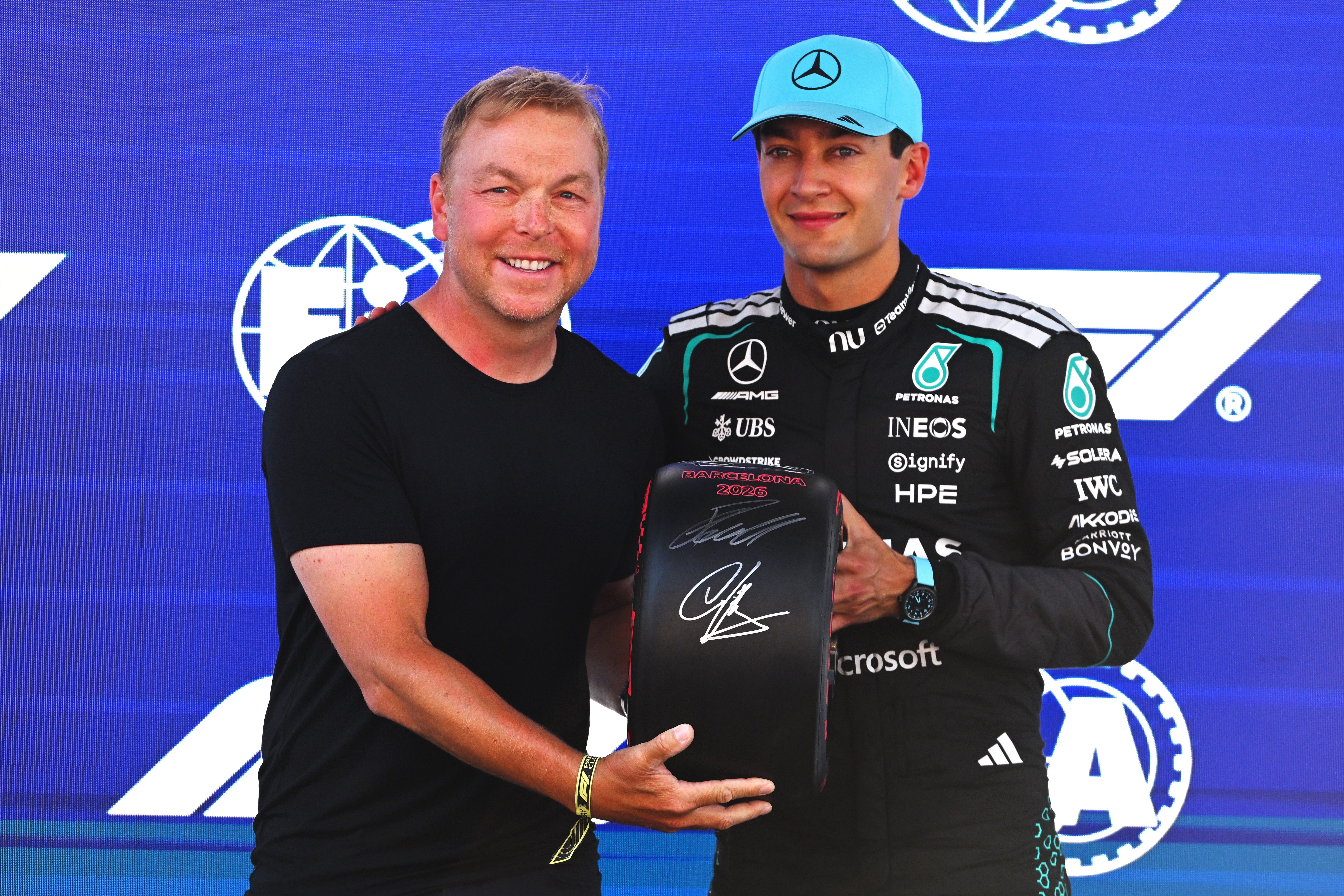 Russell with Sir Chris Hoy after claiming pole (Getty)