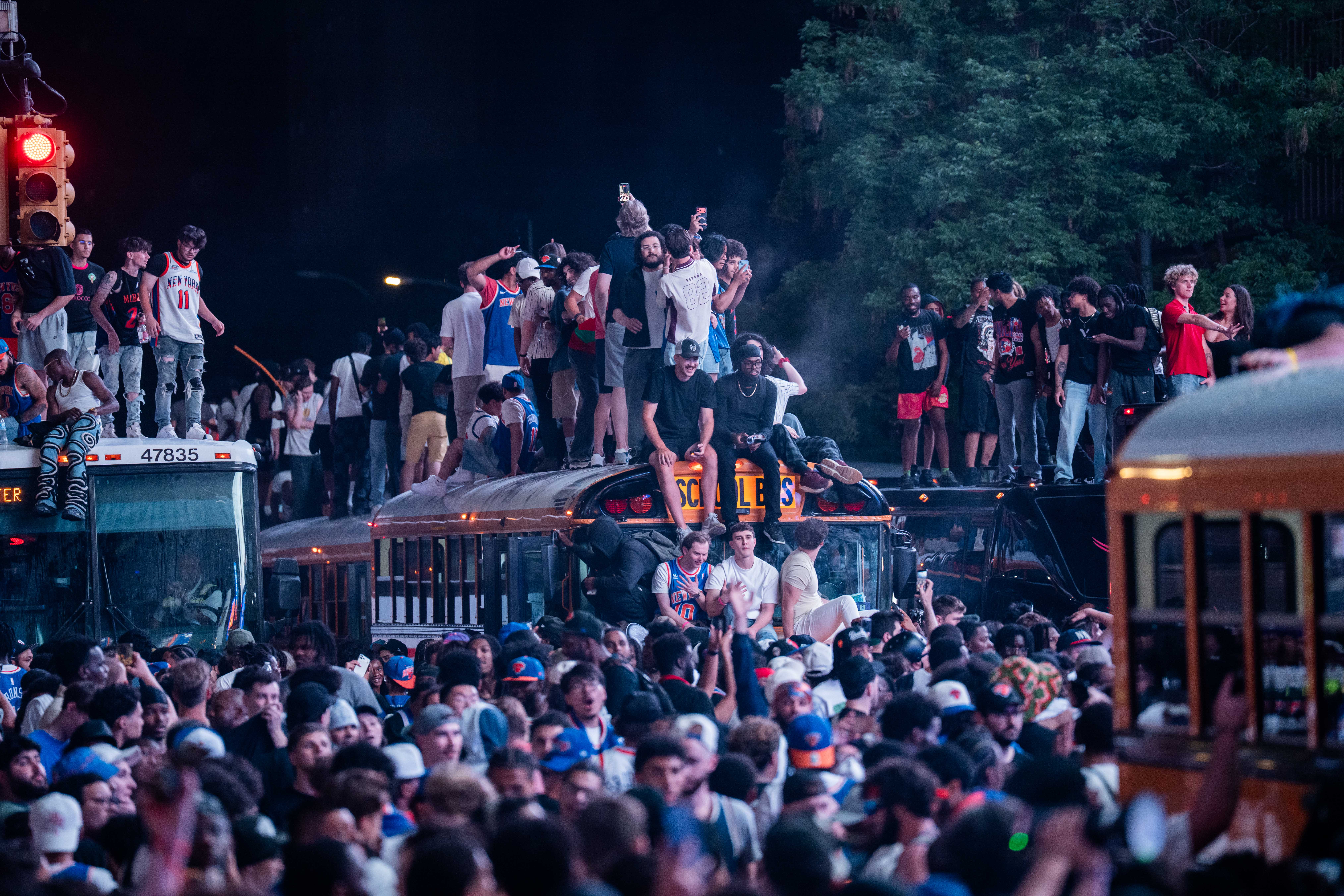 New York Knicks fans clambered on buses as they celebrated
