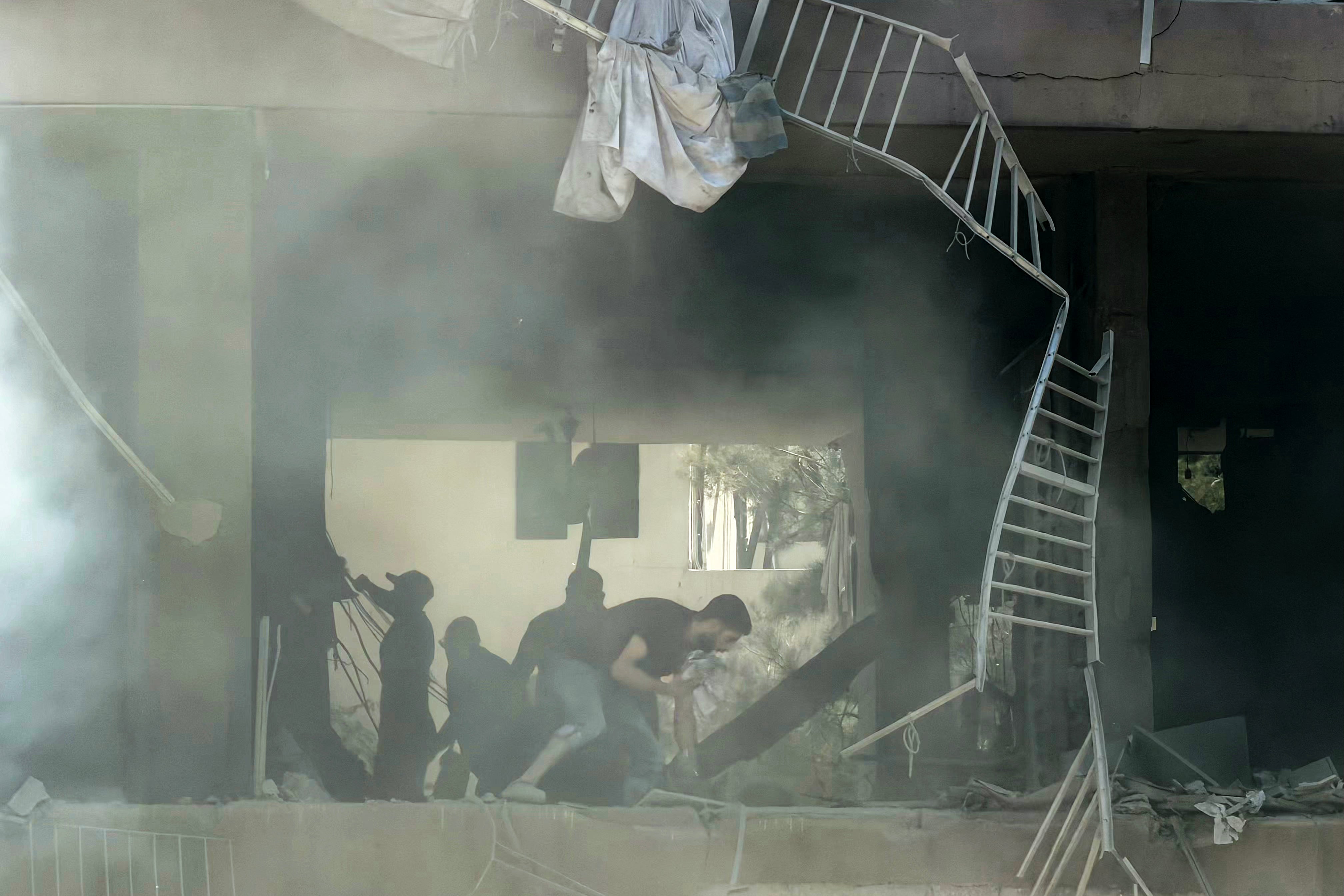 People look for survivors at the site of an Israeli airstrike