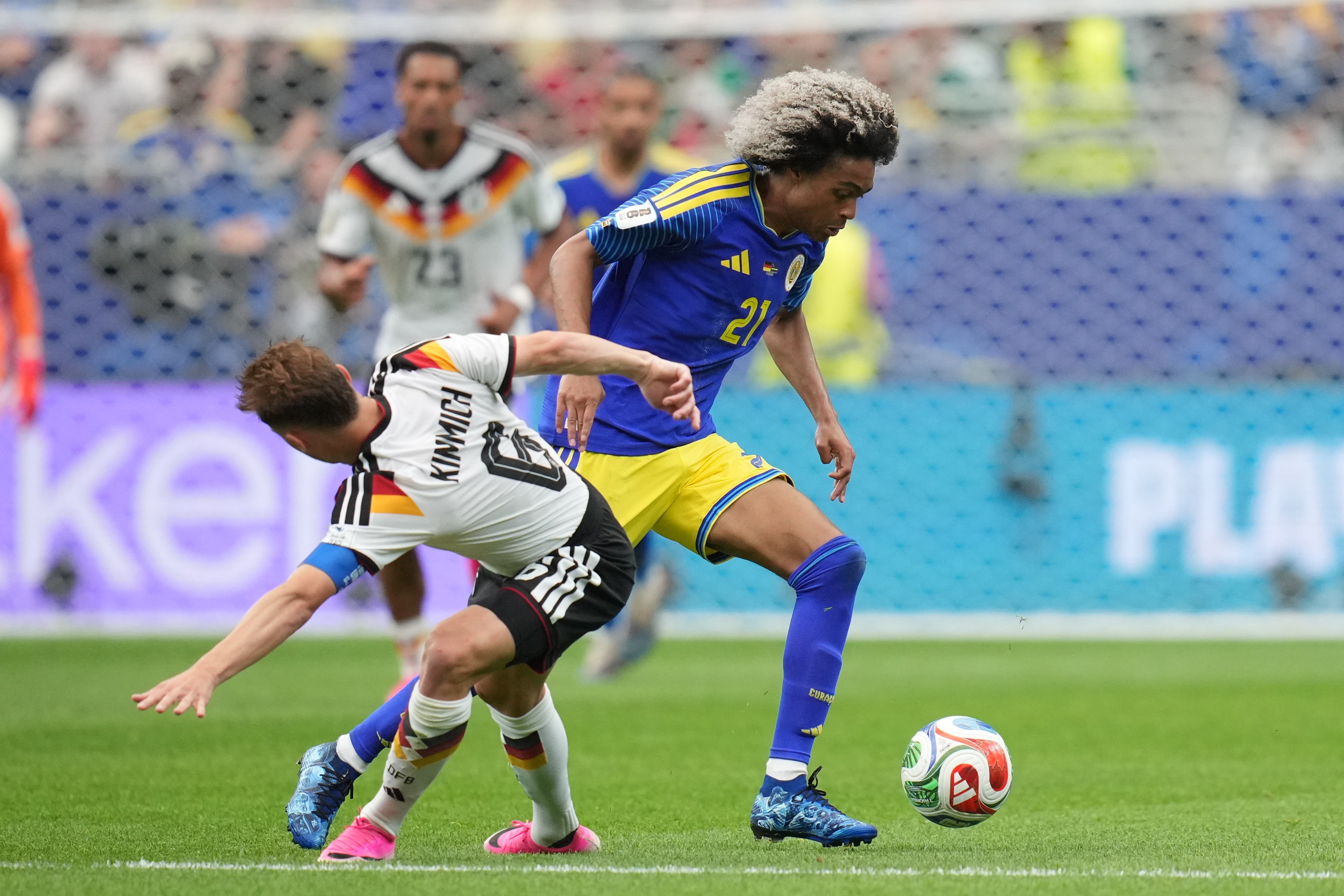 Germany's Joshua Kimmich, left, and Curaçao's Tahith Chong fight for the ball (AP)