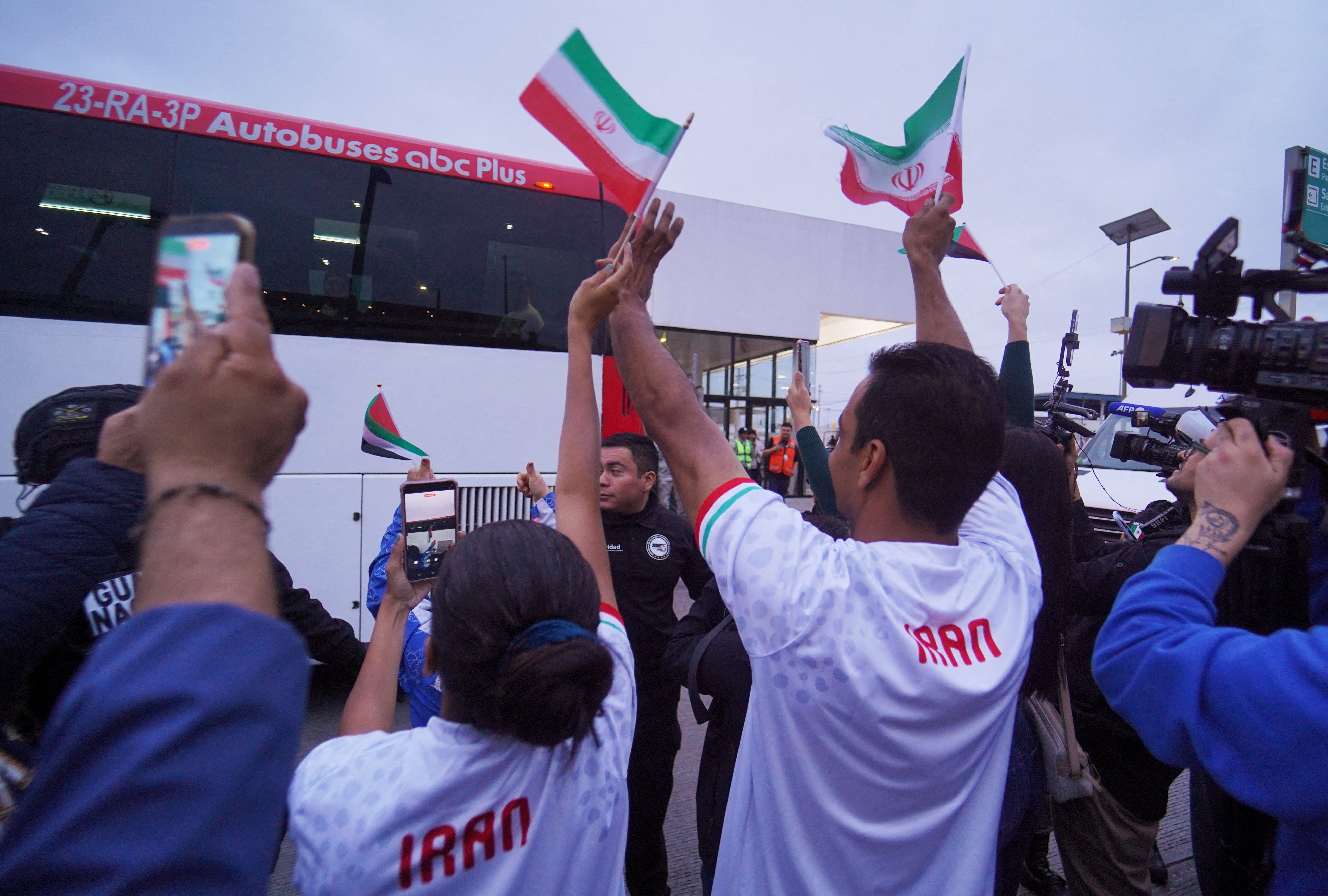 Iranian fans wave flags during the arrival of Iran’s national soccer team at Tijuana International Airport
