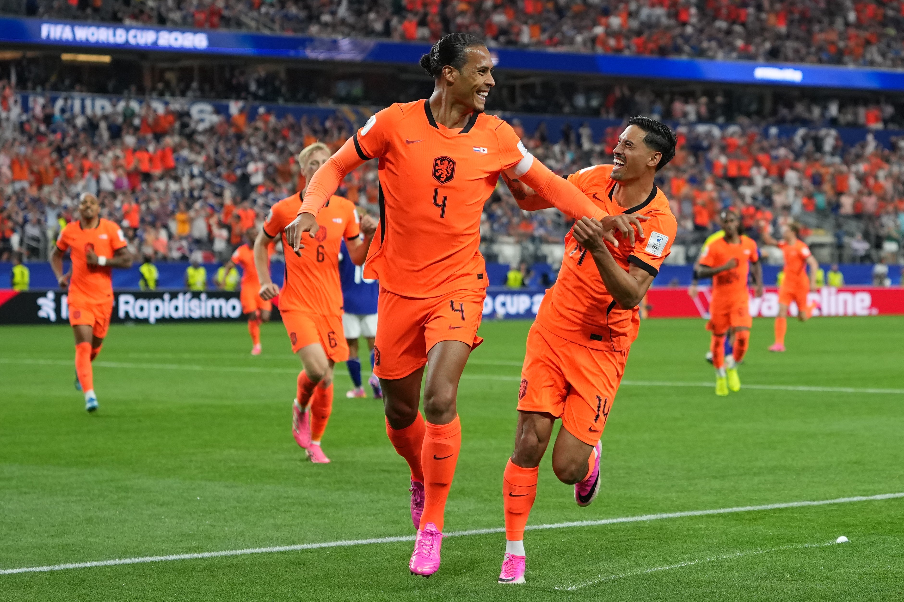 Netherlands' Virgil van Dijk (4) celebrates scoring his side's first goal against Japan
