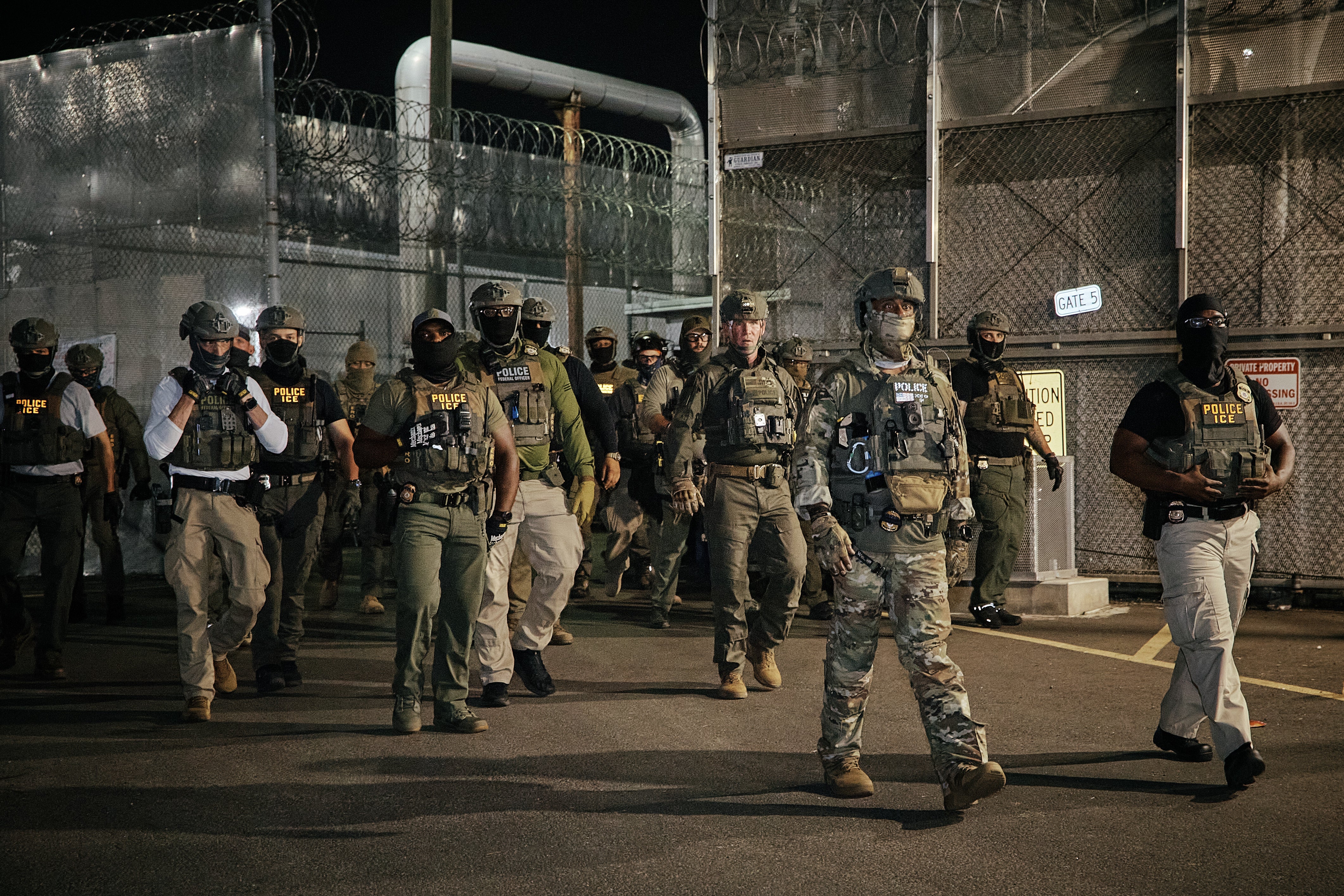 ICE agents arrive to clear protesters from a gate outside the Delaney Hall detention facility during a demonstration protesting the transfer of detainees and conditions inside the facility (Getty)