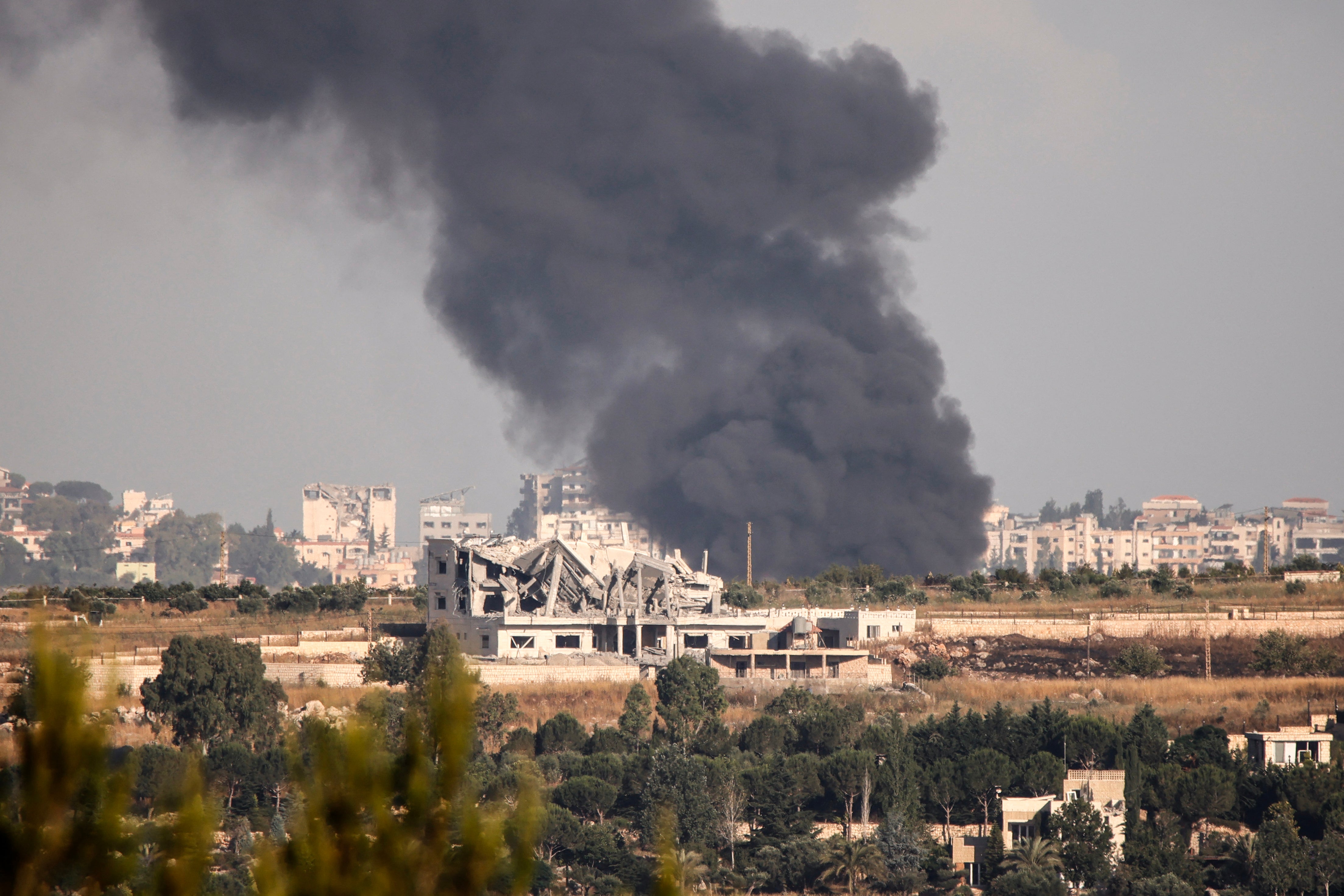Smoke billows from fires reportedly ignited at a site targeted by Israeli shelling in Kfar Tebnit, Lebanon, on 15 June
