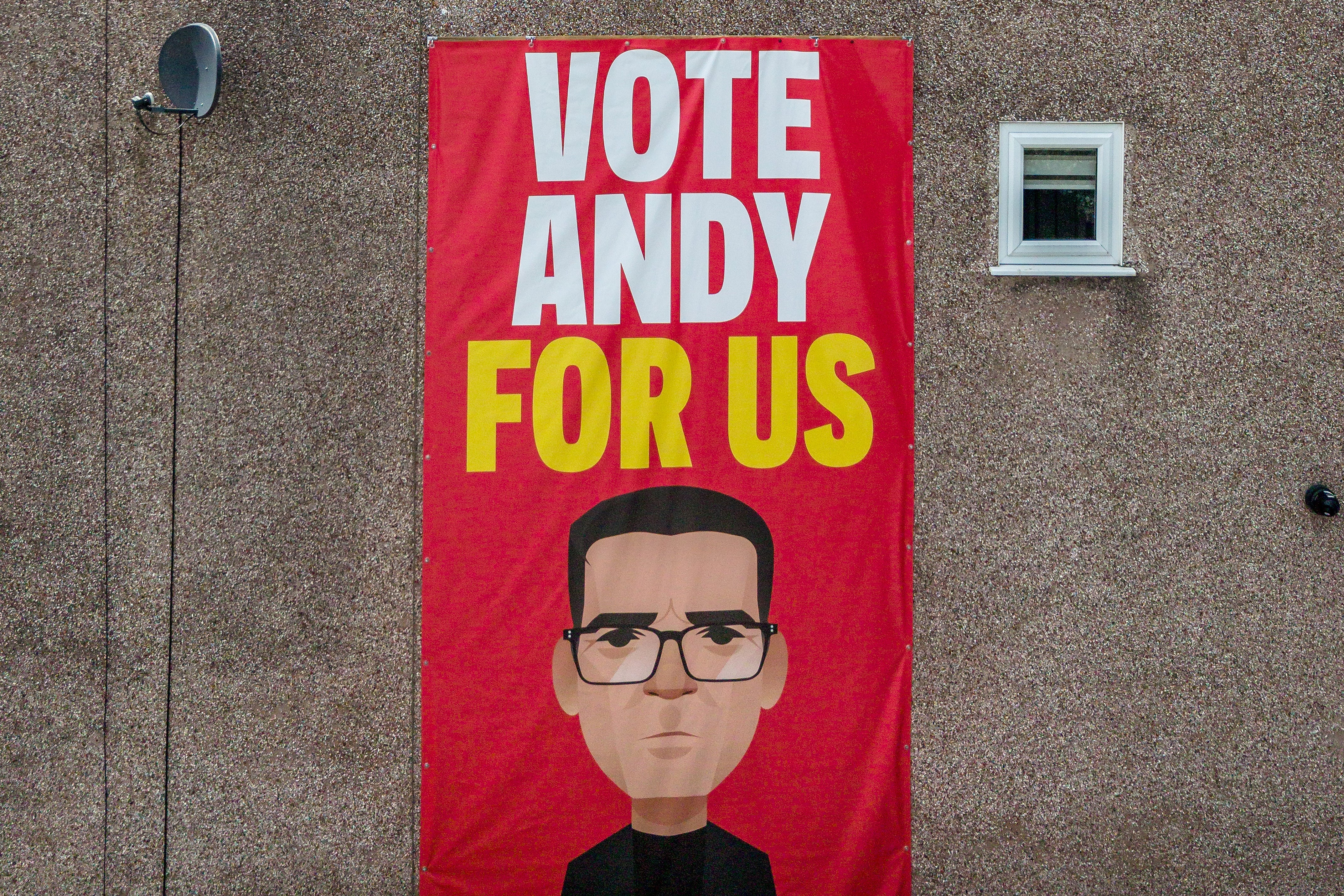 A banner adorns the side of a home in Ashton-in-Makerfield on Saturday (Getty)