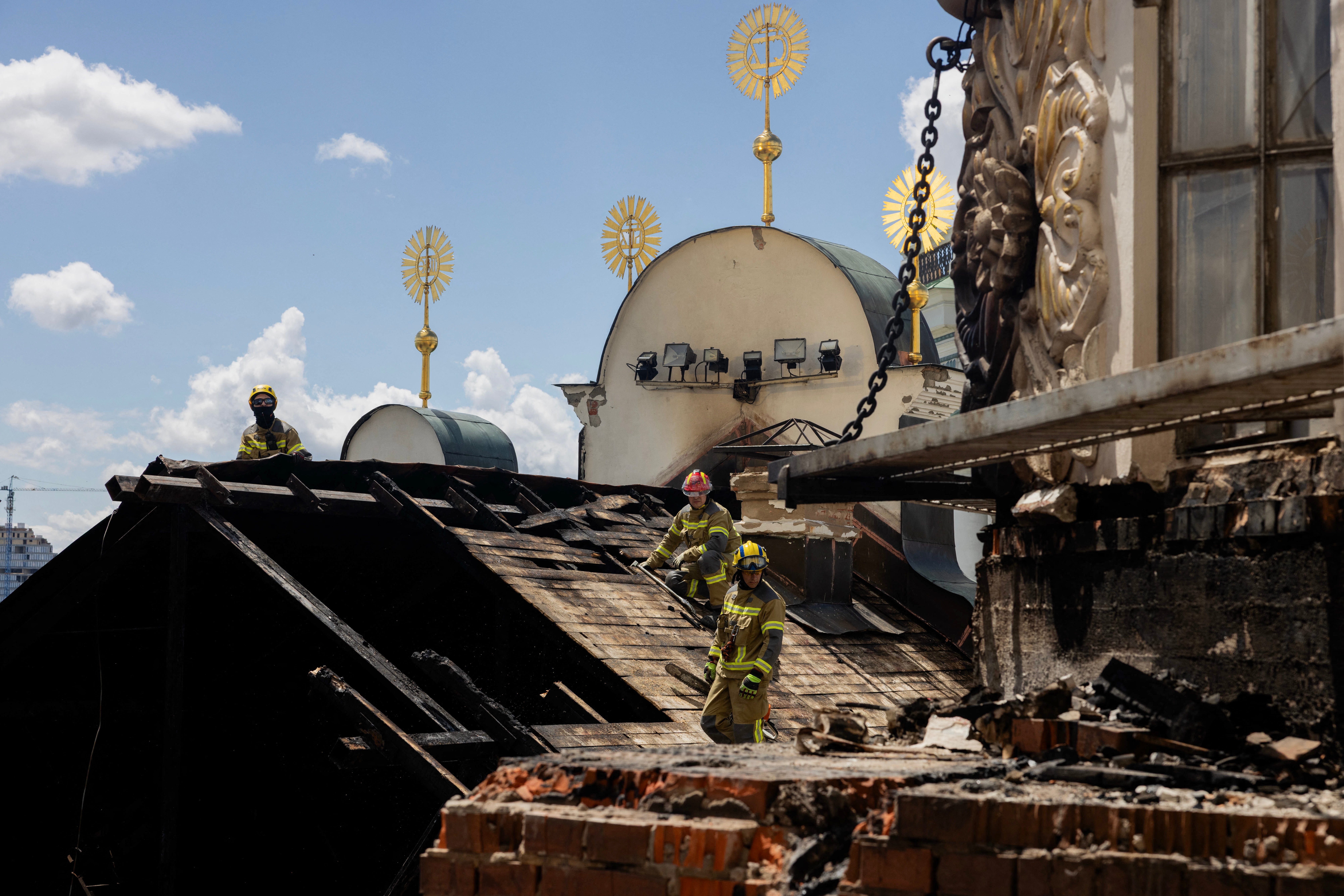 Ukrainian firefighters work at the roof of the damaged Dormition Cathedral in the Orthodox complex of the Kyiv Pechersk Lavra following a Russian missile and drone strike in Kyiv on June 15, 2026, amid the Russian invasion of Ukraine. (AFP/Getty)