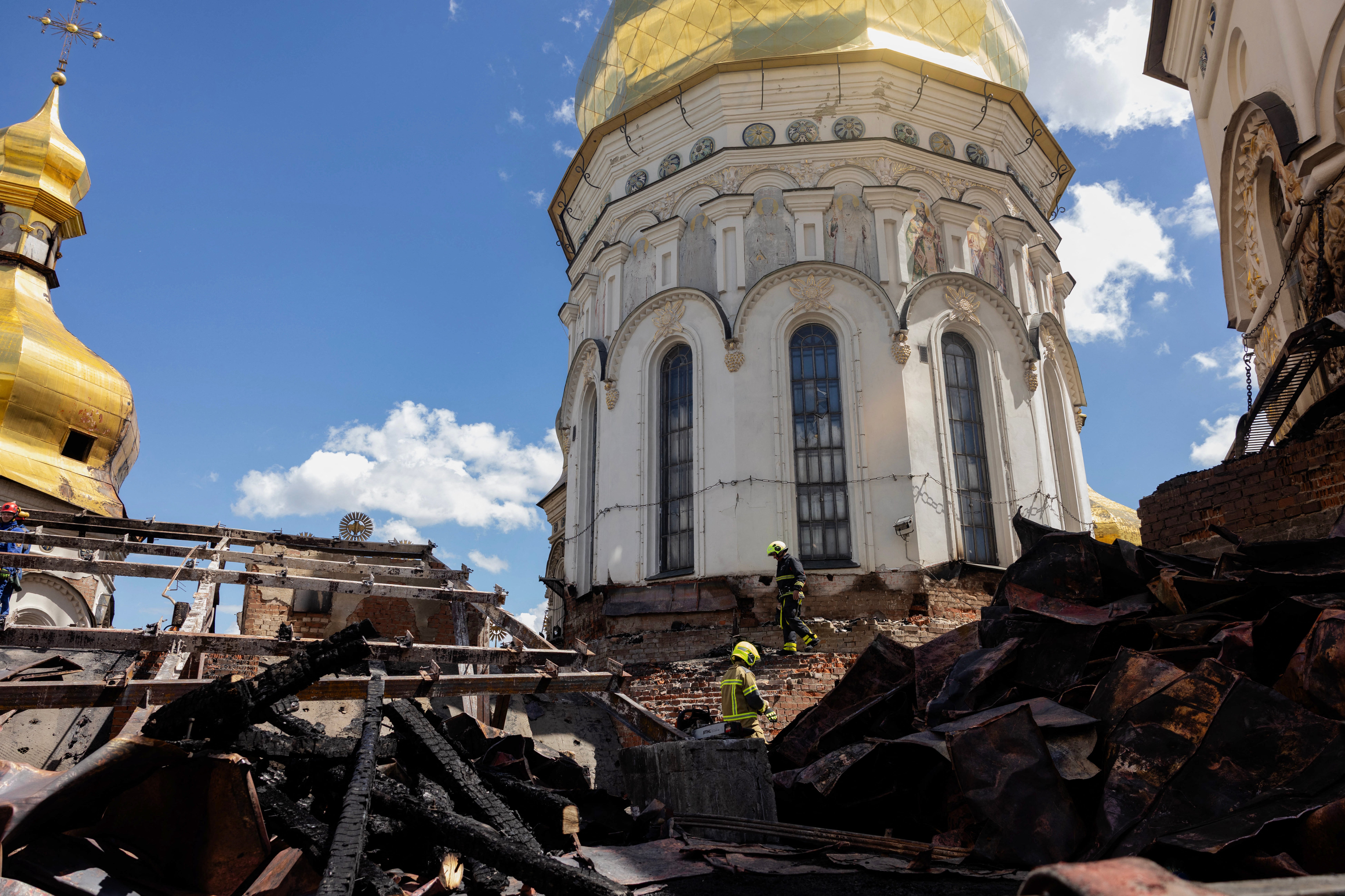 Ukrainian firefighters work at the roof of the damaged Dormition Cathedral in the Orthodox complex of the Kyiv Pechersk Lavra following a Russian missile and drone strike in Kyiv on June 15, 2026, amid the Russian invasion of Ukraine. (AFP/Getty)