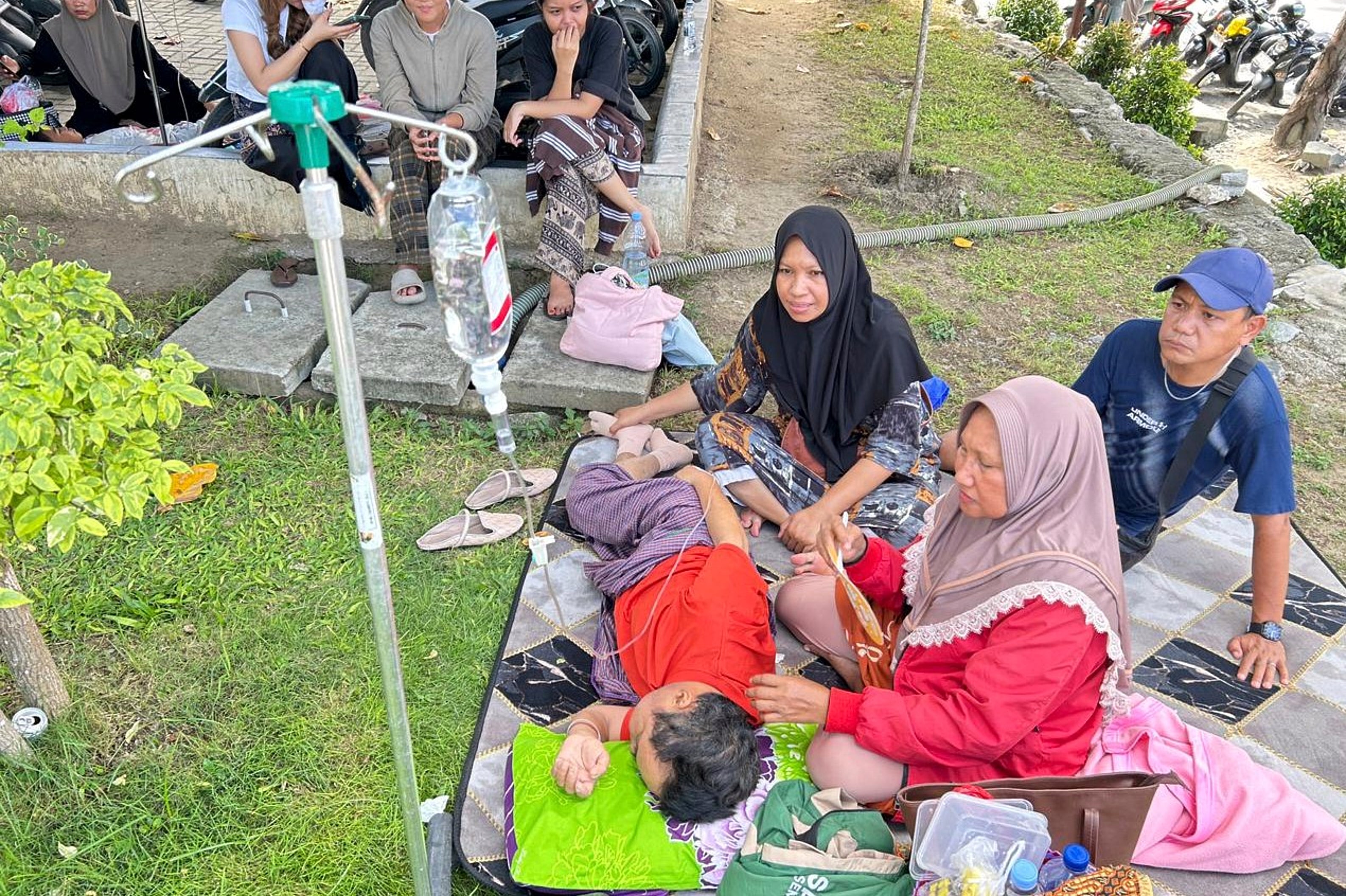 Patients sit outside a hospital following an earthquake in Palu, Indonesia, on 16 June 2026
