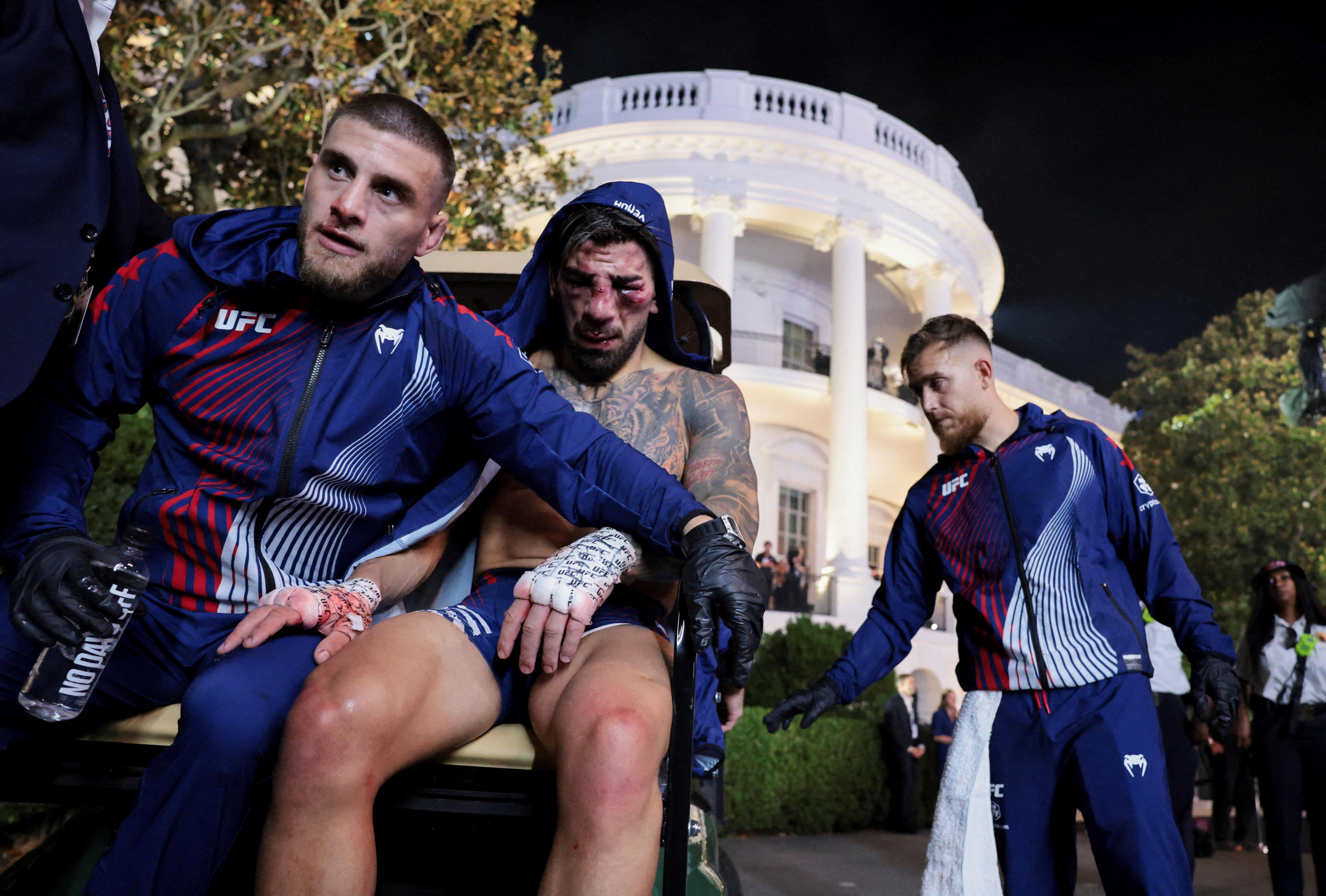 Ilia Topuria (centre) after his stoppage loss to Justin Gaethje