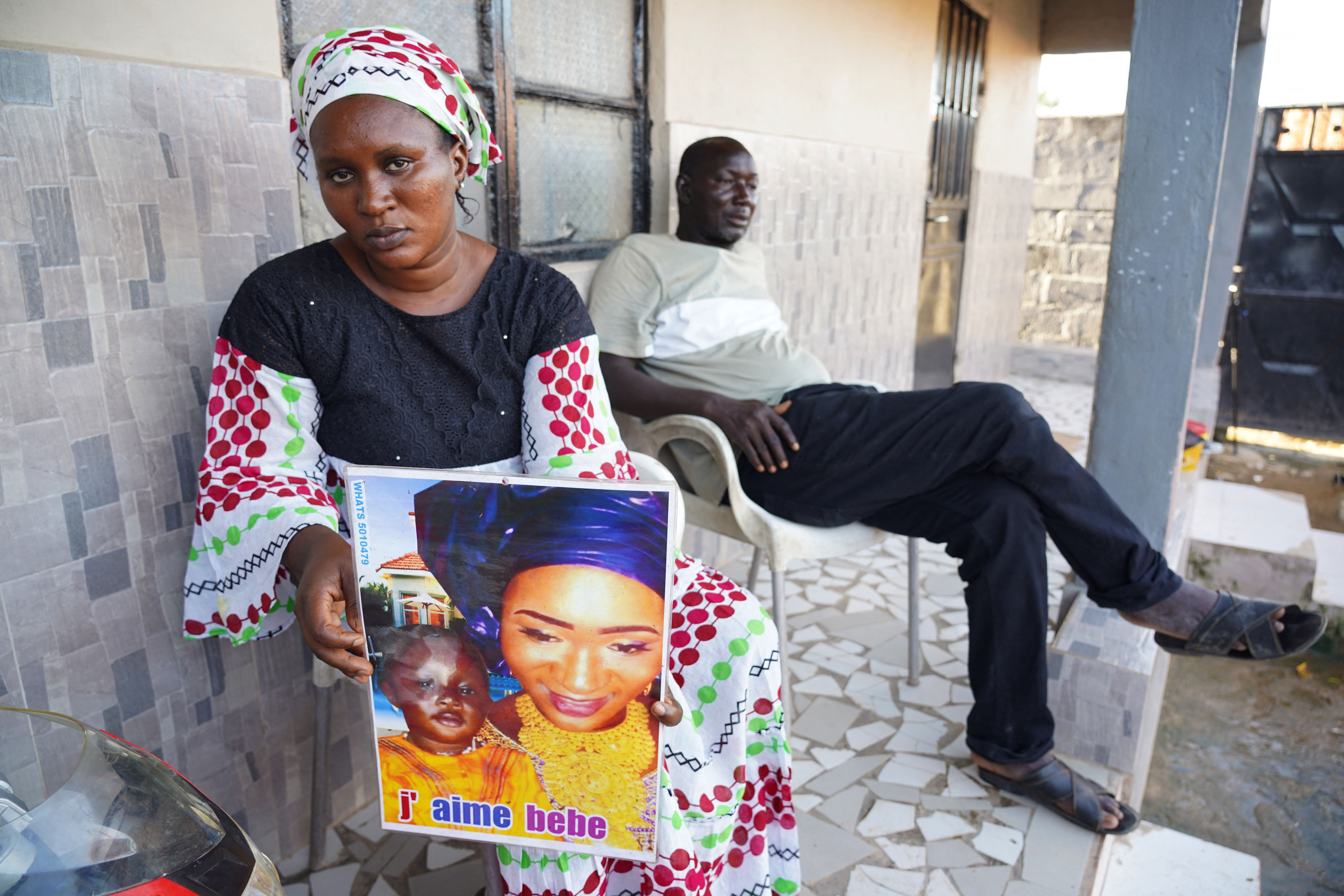Mariama Kuyateh, 30, holds up a picture of her son who died from acute kidney failure in 2022. Gambian police announced an investigation into four cough syrups made by India’s Maiden Pharmaceuticals after the WHO said they could be responsible for the deaths of 66 children in the country (AFP/Getty)