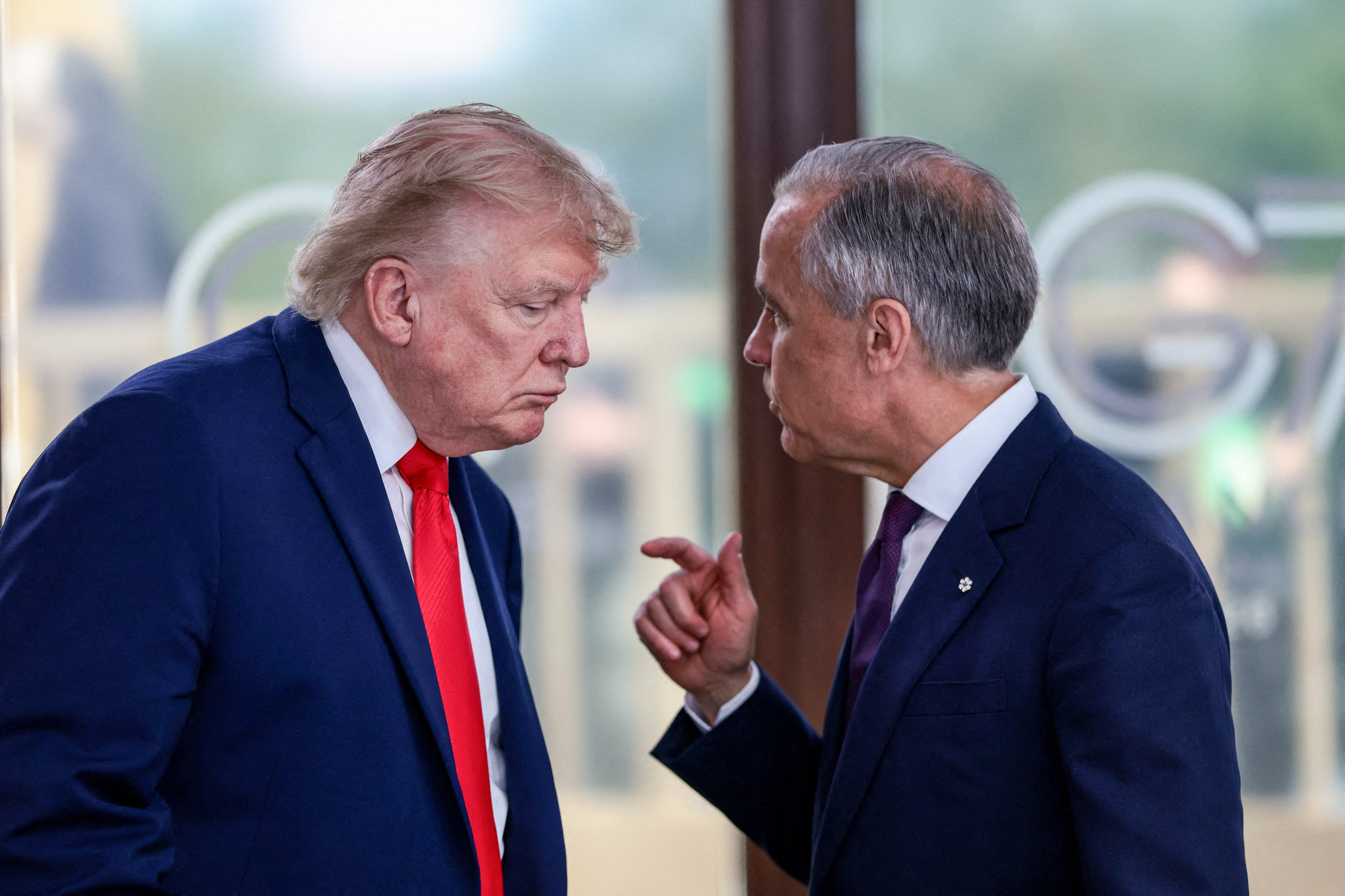 Trump has paused tariffs against Canadian imports after meeting with Canadian Prime Minister Mark Carney (right) (AFP/Getty)