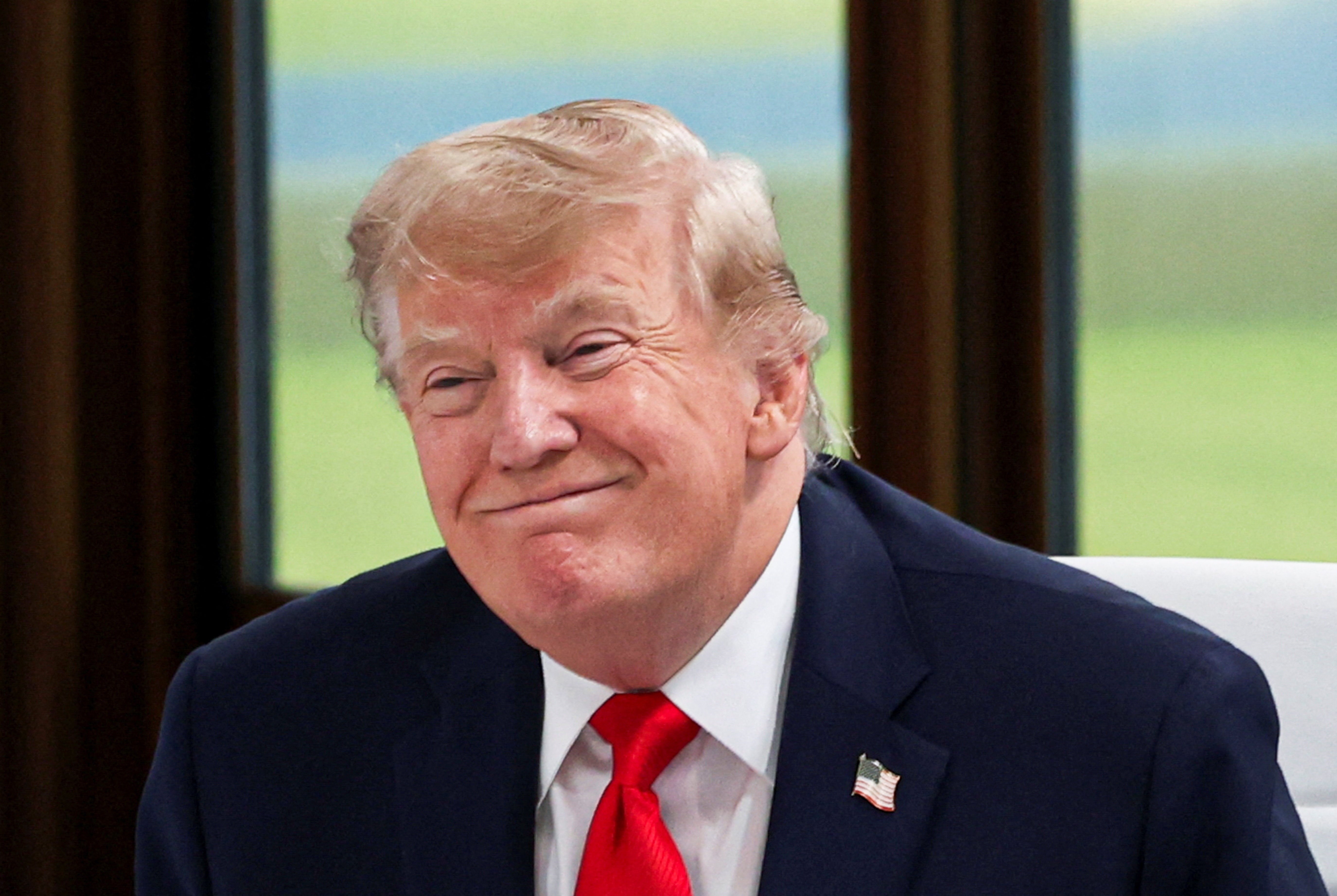 U.S. President Donald Trump reacts during a working session with G7 leaders
