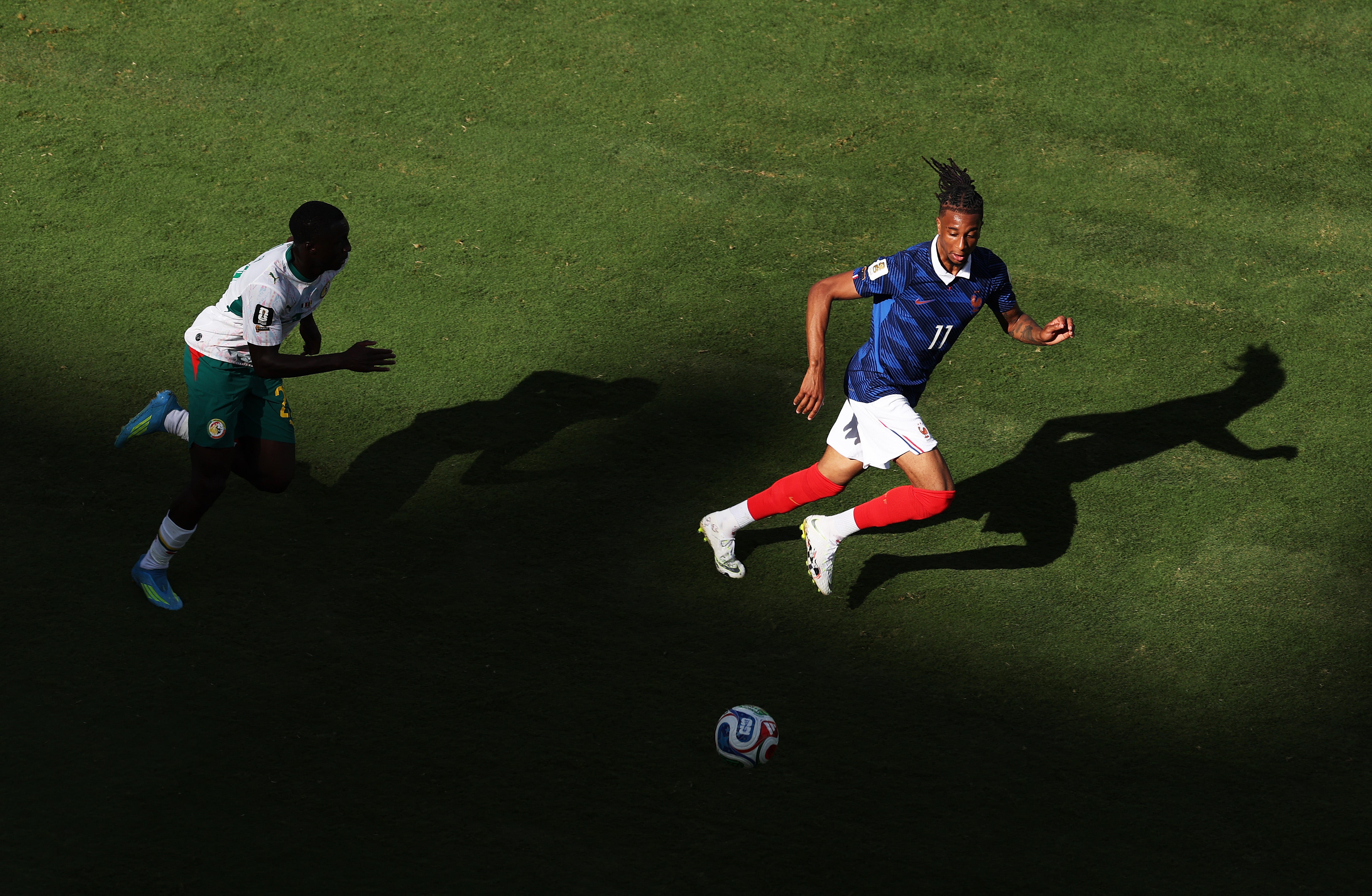Michael Olise #11 of France chases after a loose ball