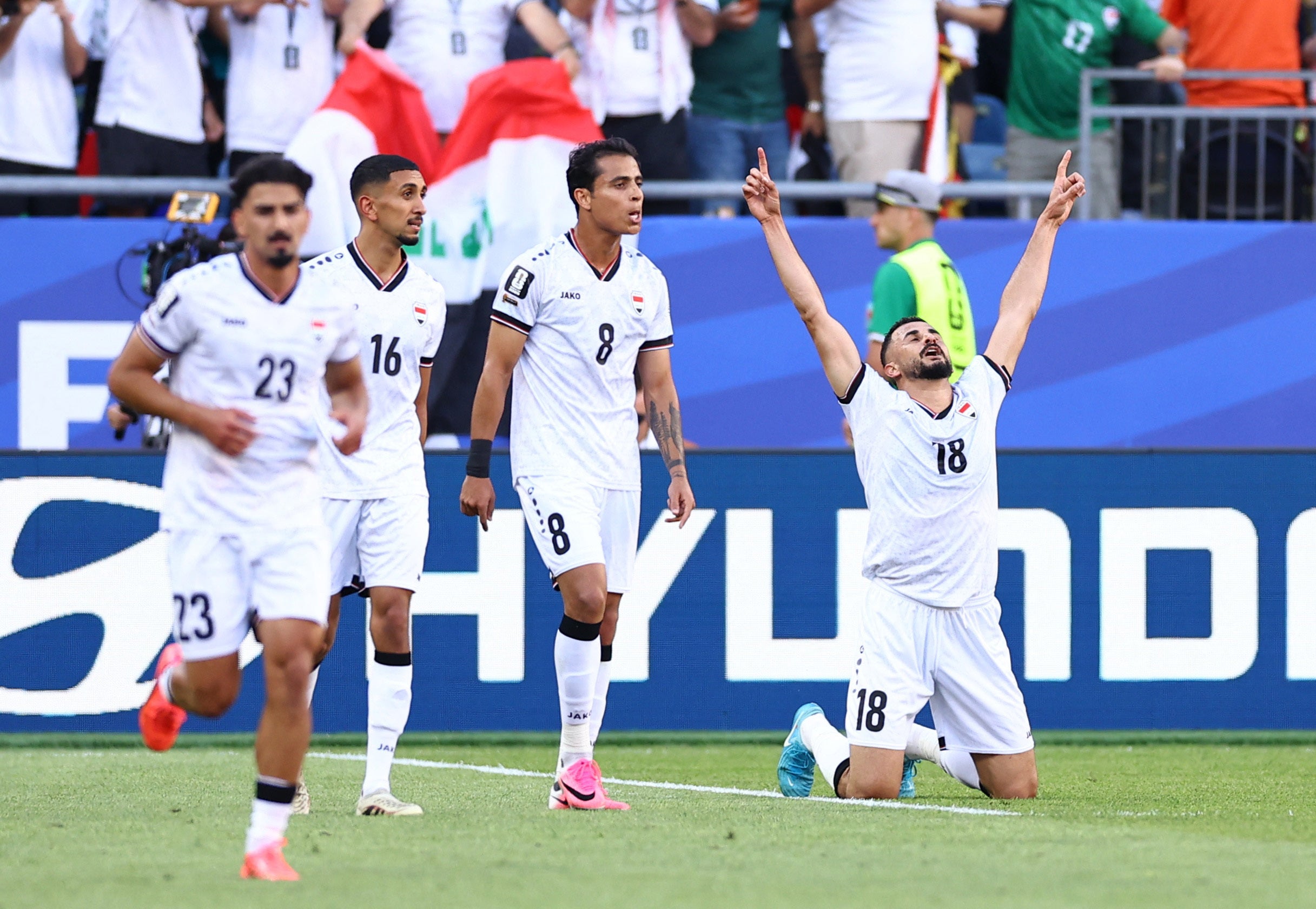 Iraq's Aymen Hussein celebrates scoring their first goal