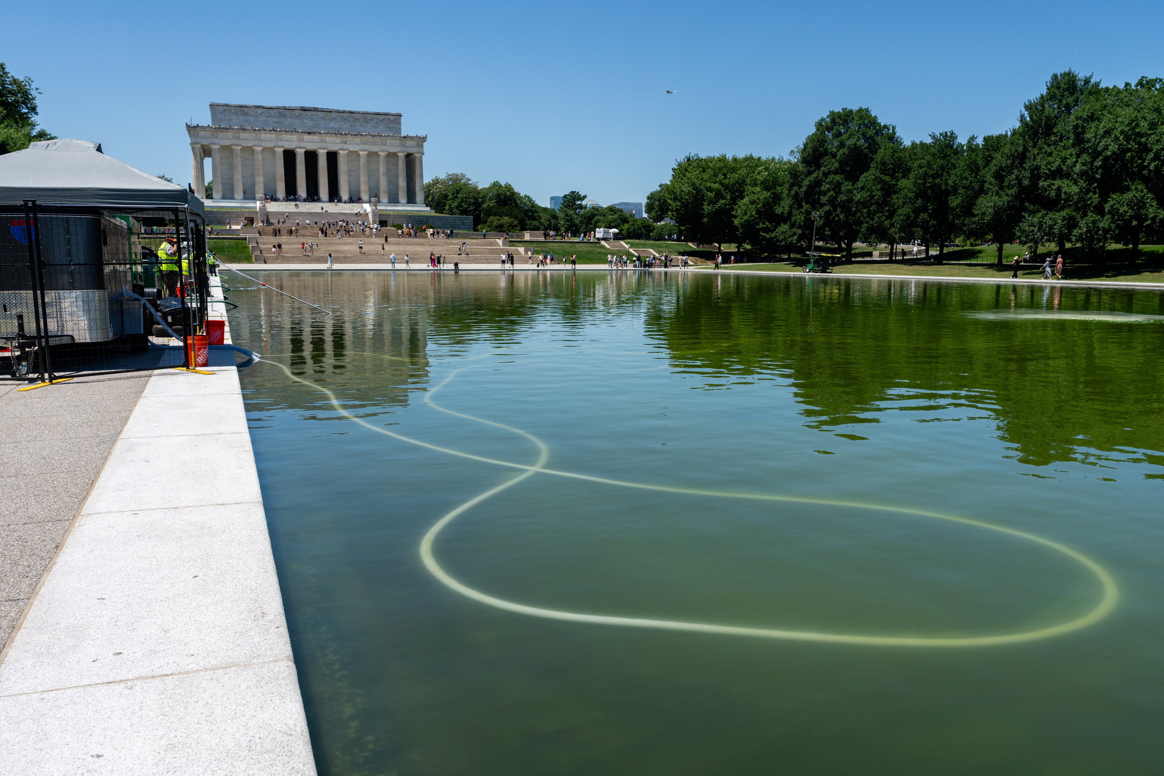 The National Park Service was hard at work Tuesday attempting to clean the Reflecting Pool (Reuters)