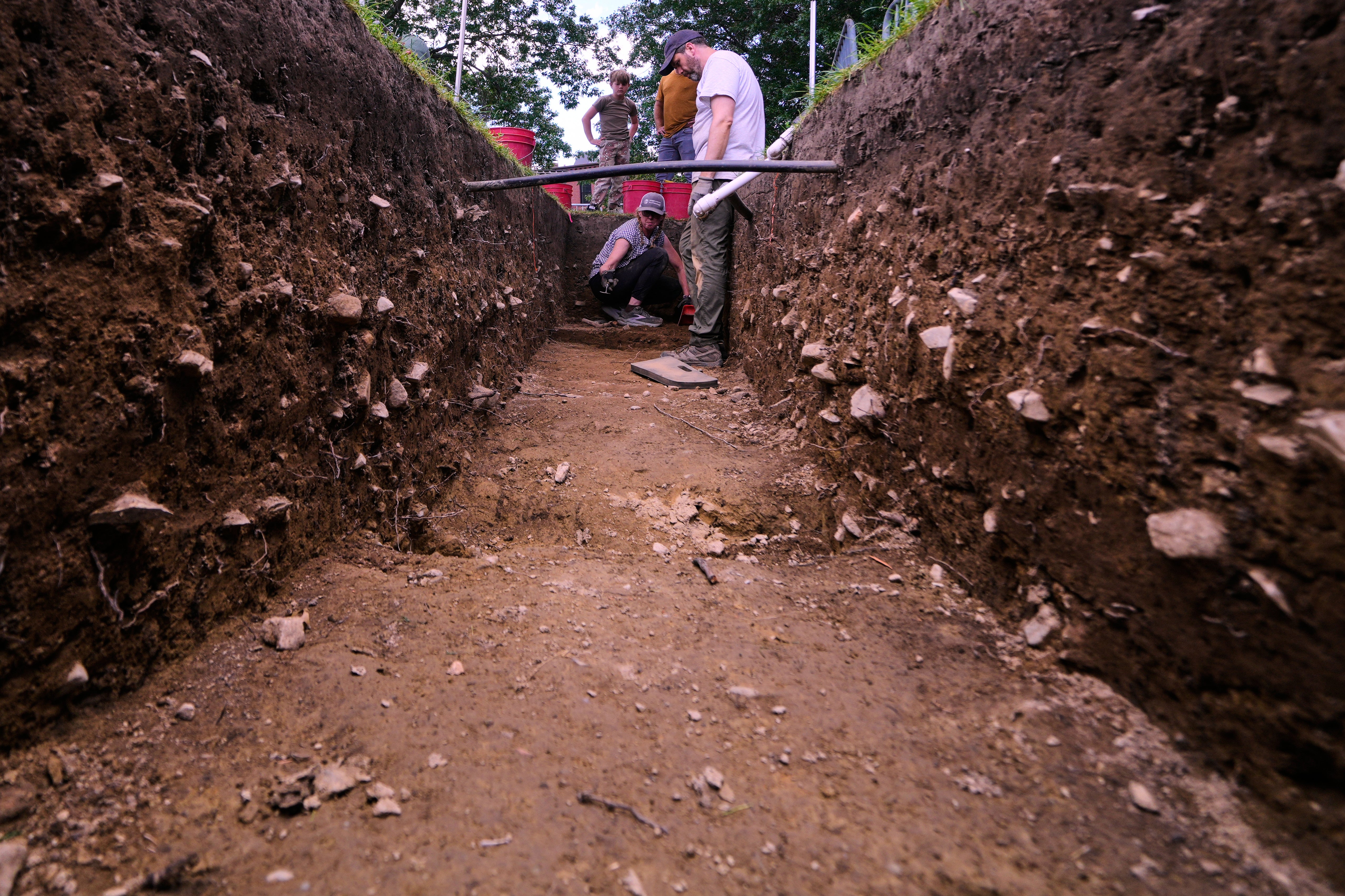 Joe Bagley, right, the City of Boston Archeologist, talks with with Sarah Kiley Schoff, a forensic anthropologist, during an archaeological dig at the site