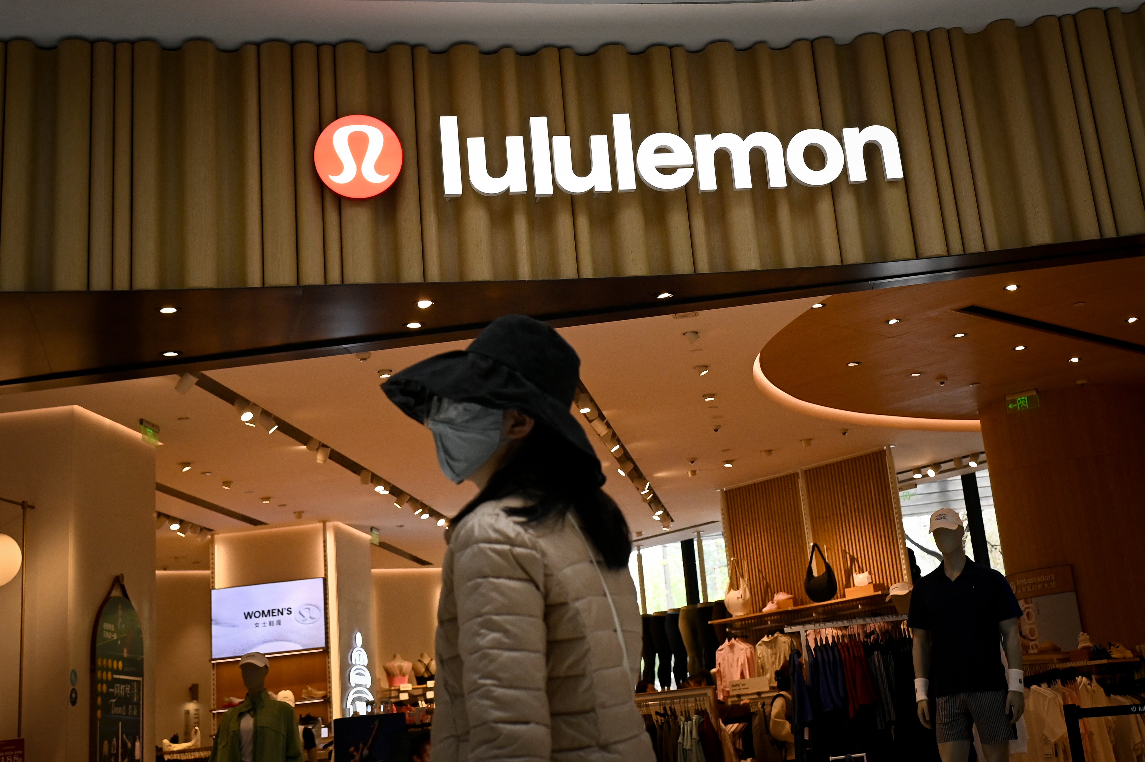 A shopper walks past a Lululemon store in Beijing on 15 April 2026
