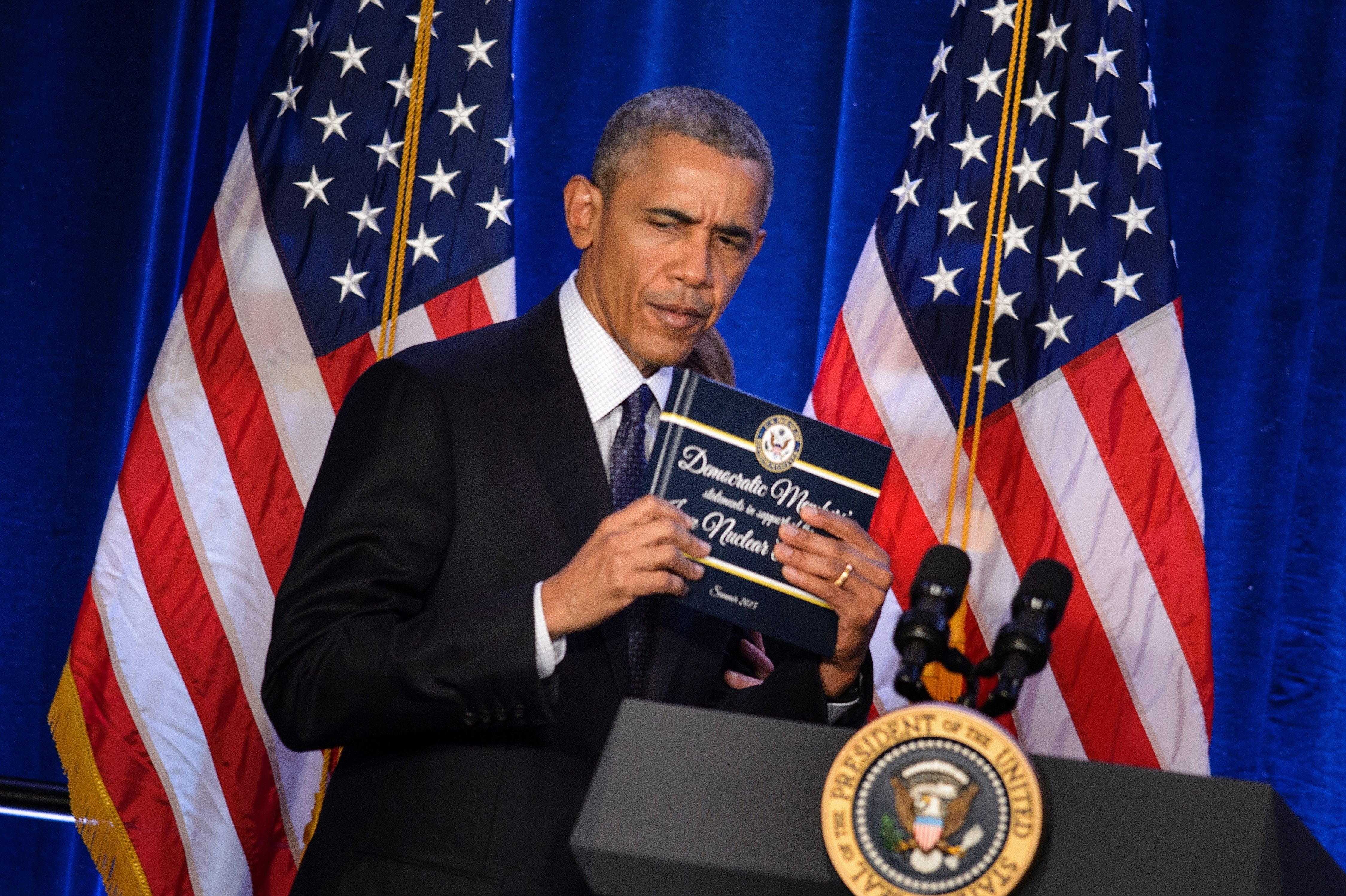 In his 2015 tweet, Trump heavily criticized the Iran nuclear deal signed during Obama's second term. Pictured here, Obama holds a copy of the Iran nuclear agreement presented to him by House Minority Leader Nancy Pelosi on January 28, 2016 (AFP via Getty Images)