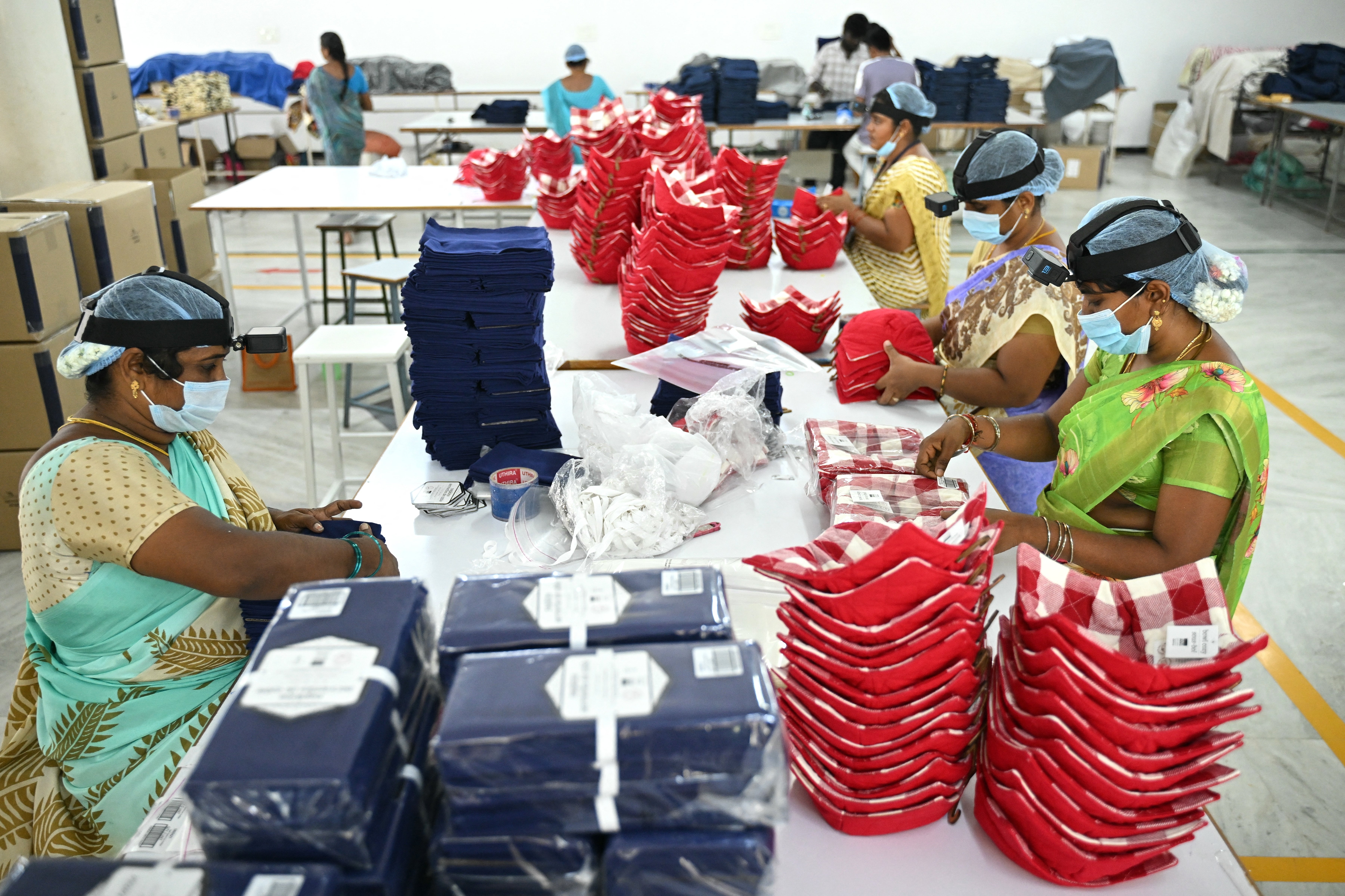 This photograph taken on 12 May 2026 shows women working inside a factory in Tamil Nadu's Karur district