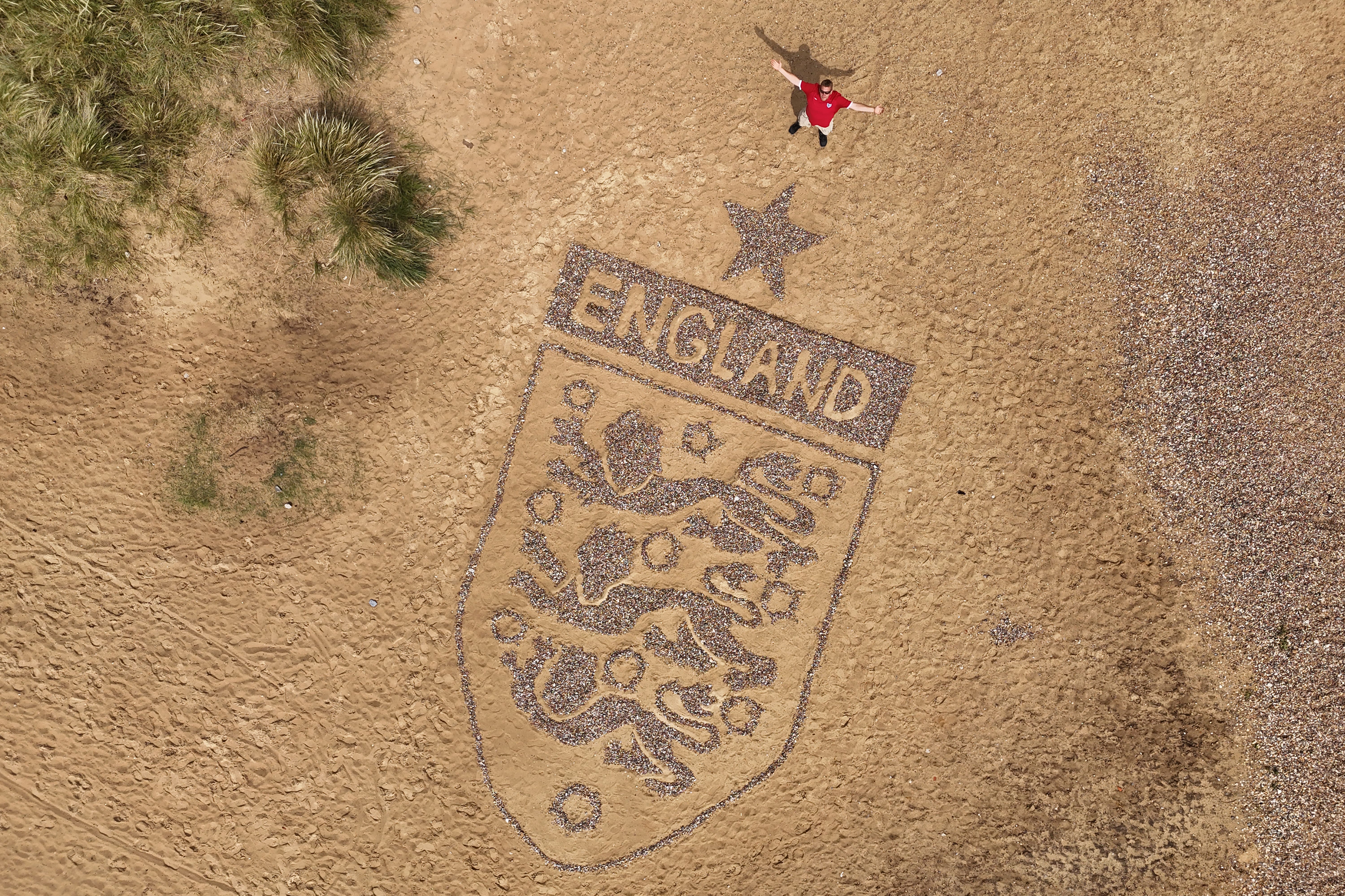 A giant England badge made by artist Toby Clark using stones found on the beach near Lowestoft, Suffolk