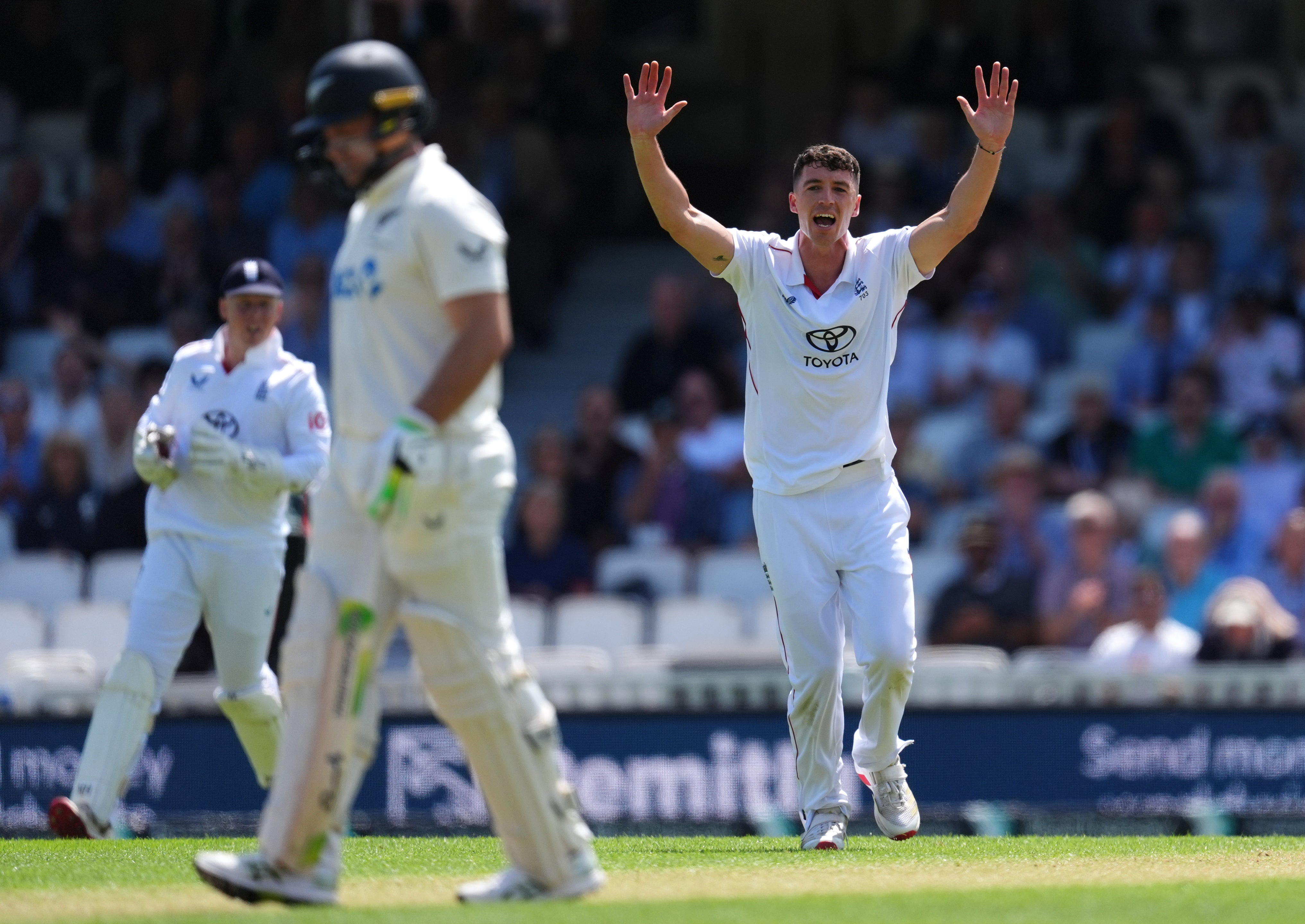 England’s Matt Fisher celebrates the dismissal of Devon Conway (Ben Whitley/PA)