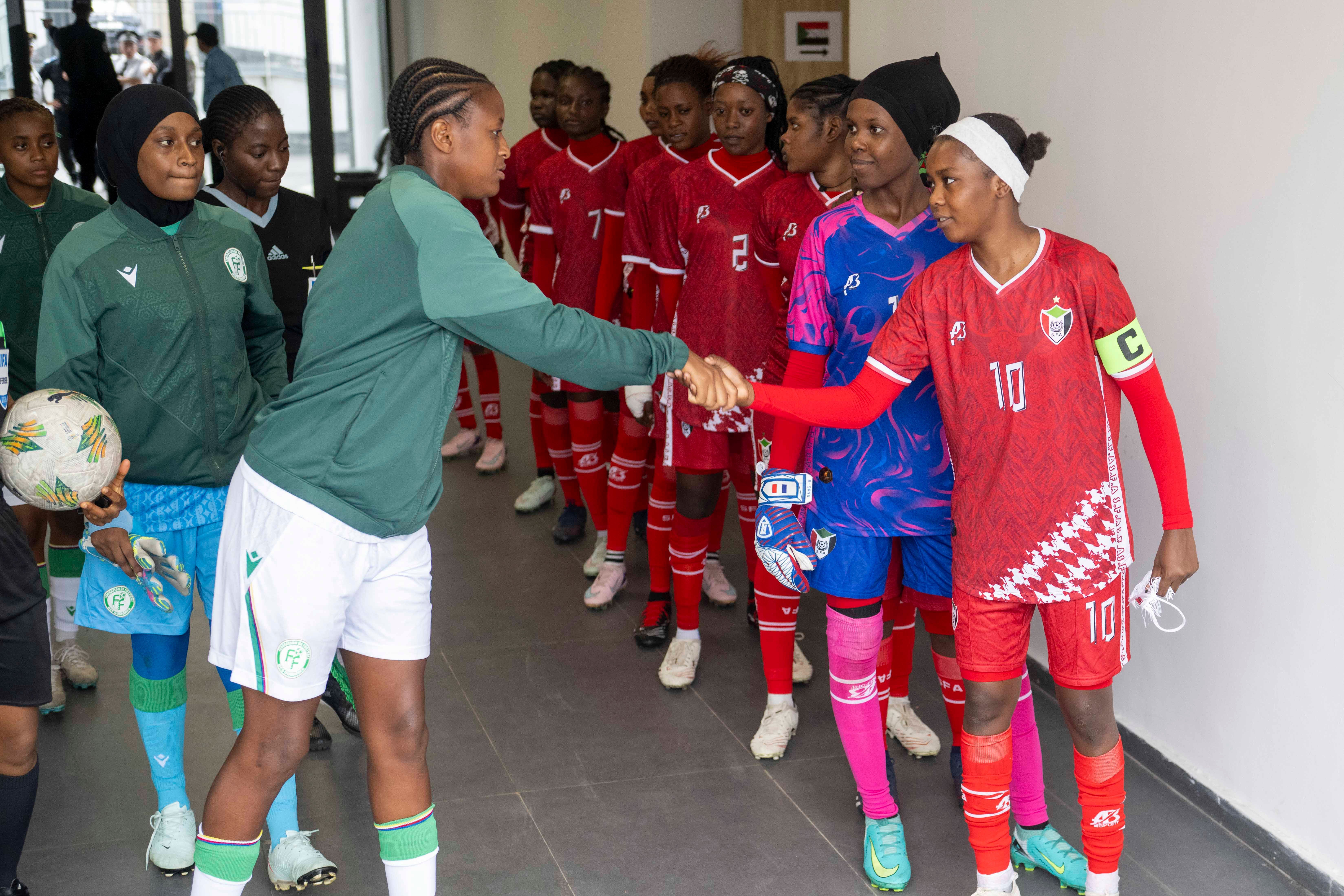 Sudan's women shake hands with their opponents (AP)