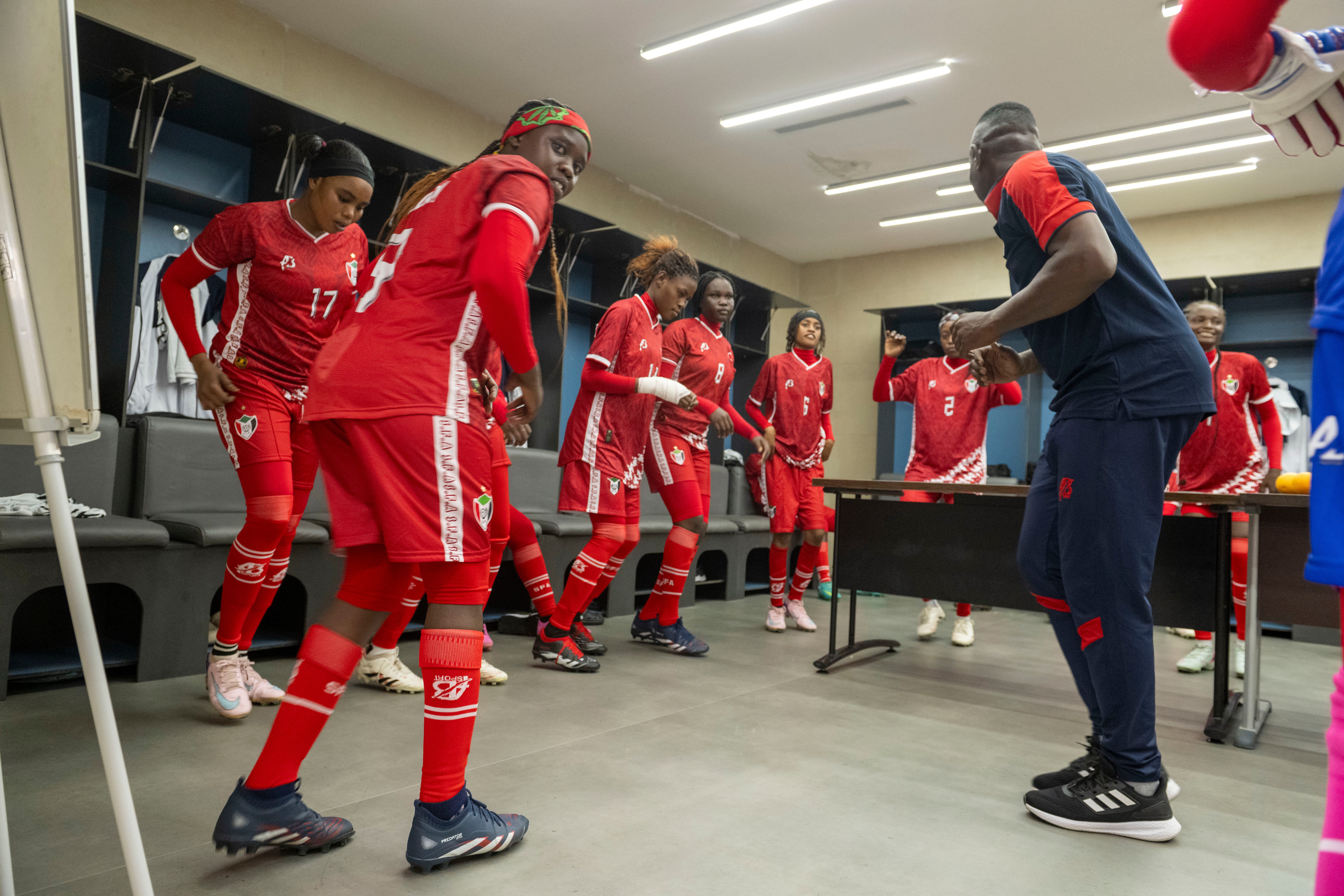 The team warms up in the changing room (AP)