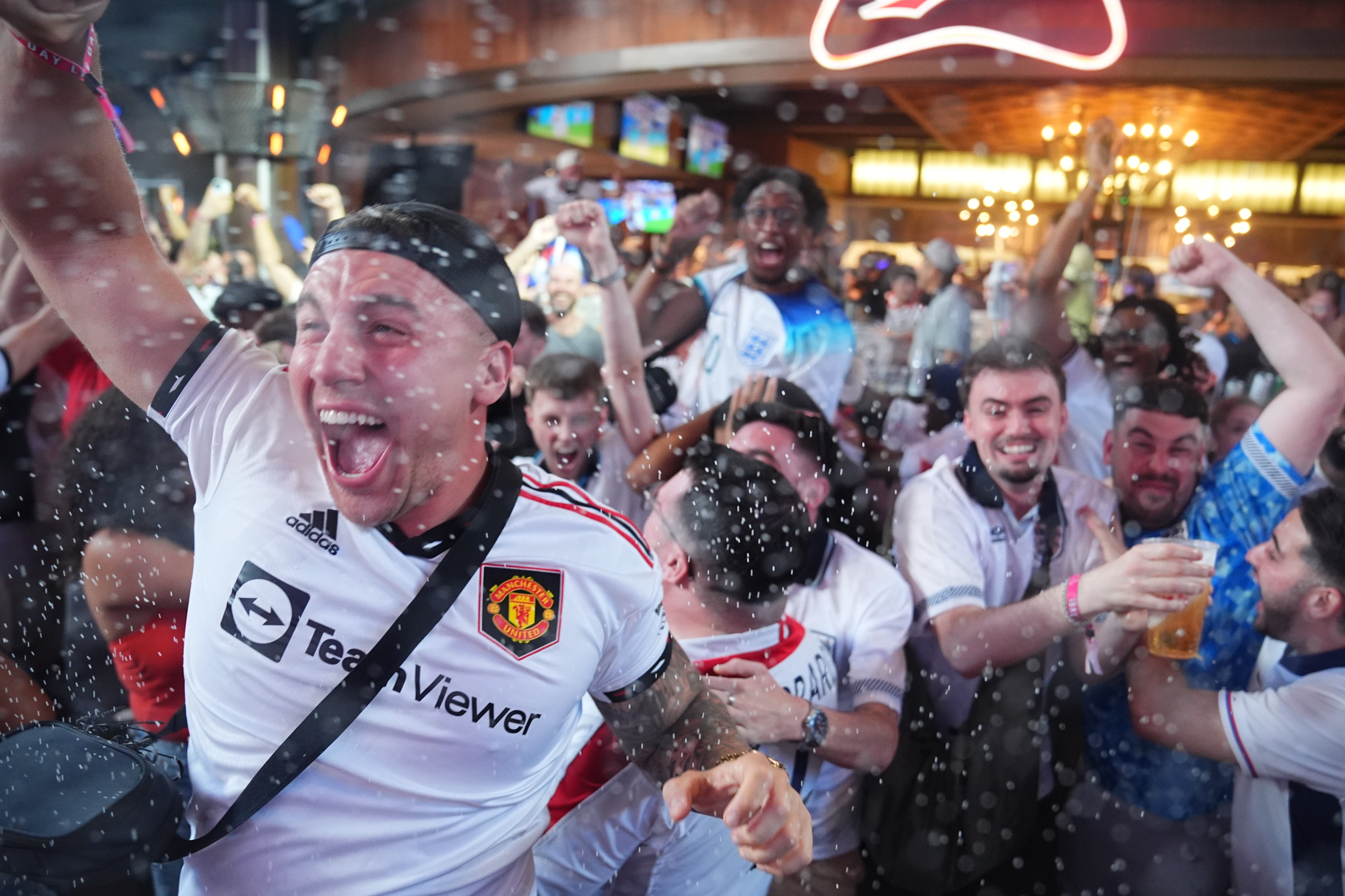 England supporters in the Texas Live! bar in Arlington celebrate after England score their fourth goal of the game (James Manning/PA) (PA Wire)