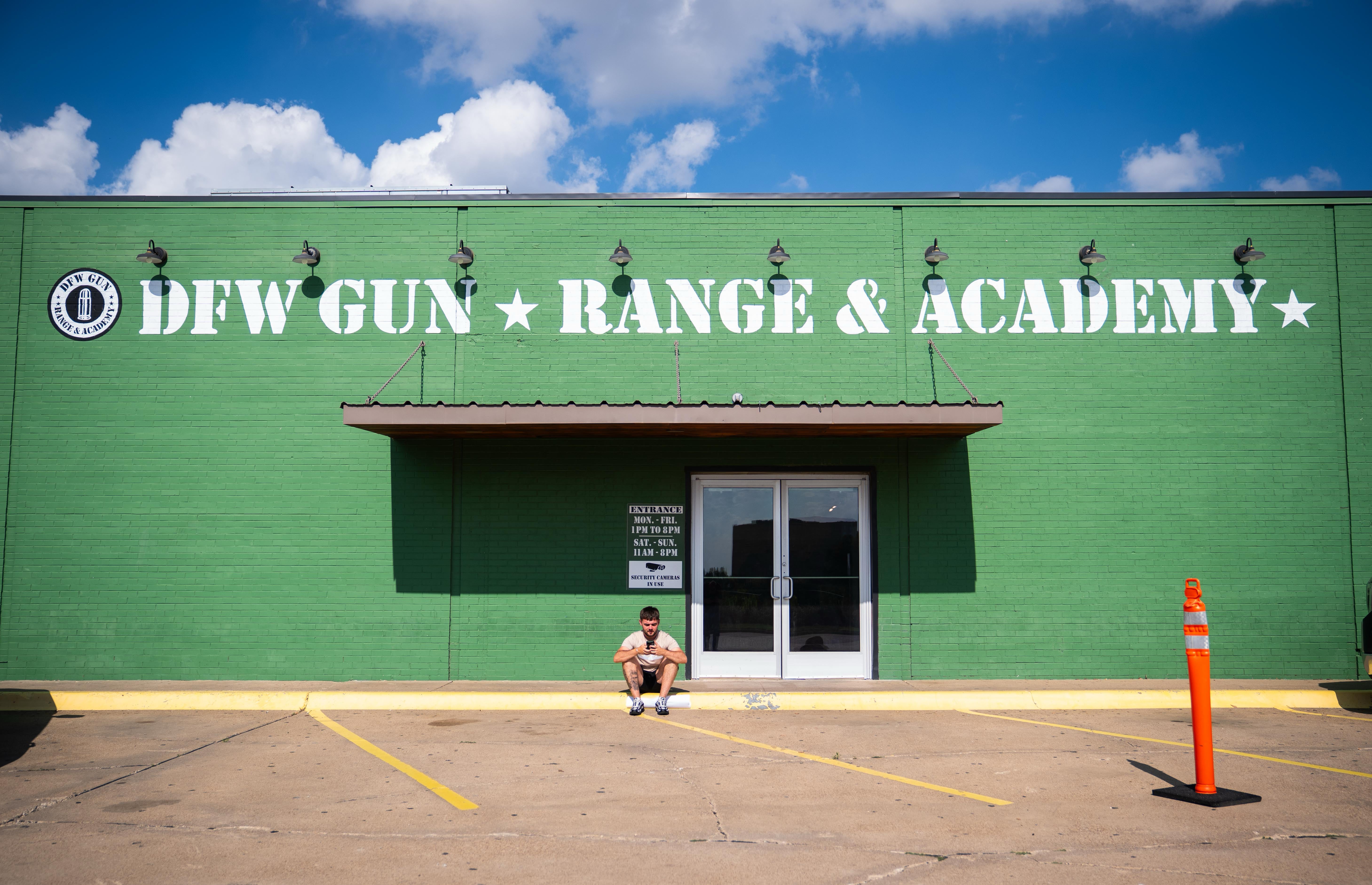 An England fan sits outside the DFW Gun Range and Academy in Dallas