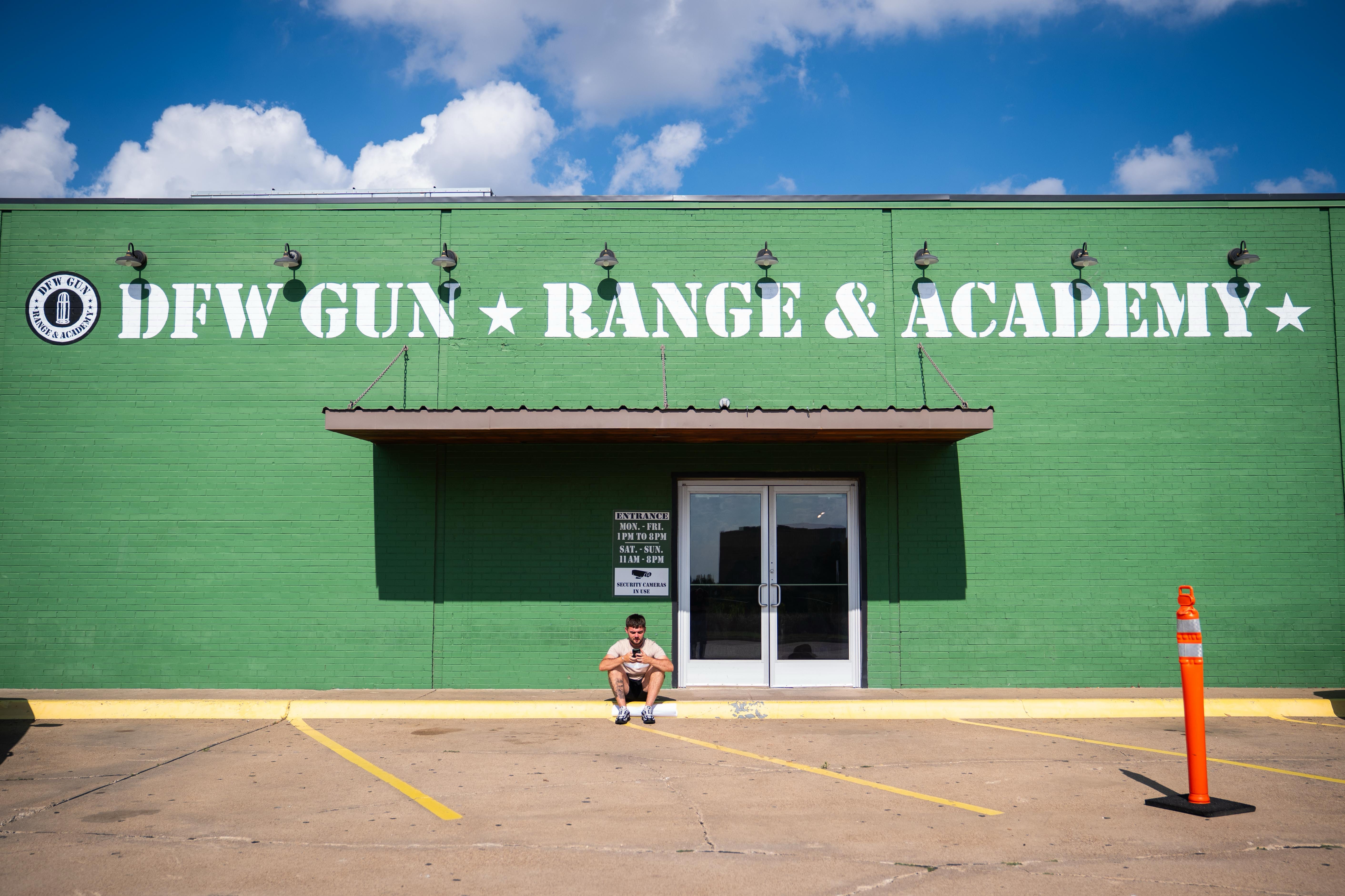 An England fan sits outside the DFW Gun Range and Academy in Dallas (PA)