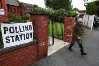A person walks outside a polling station during the Makerfield byelection