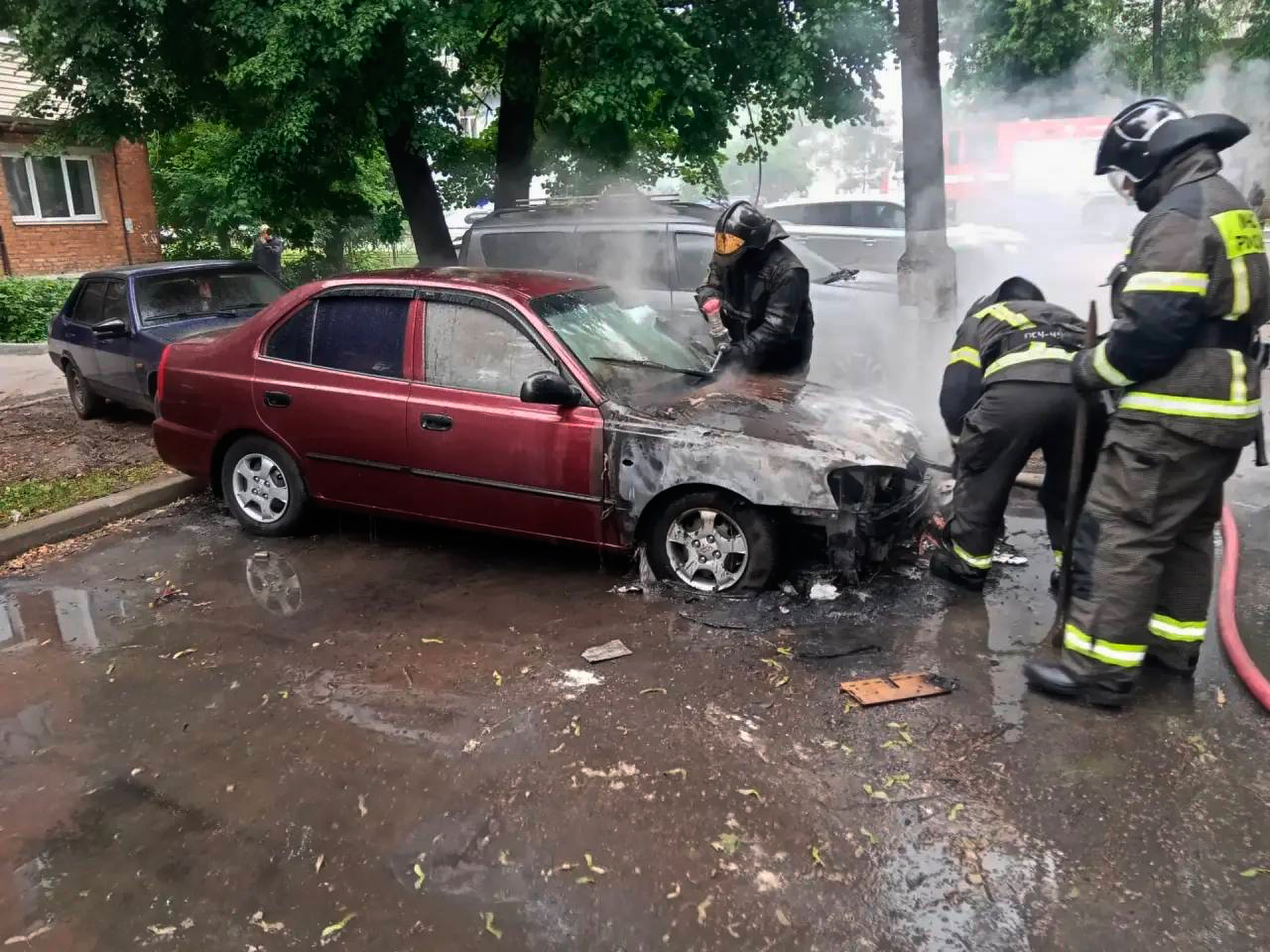 Firefighters extinguish a burning car after a Ukrainian drone attack outside Moscow (AP)
