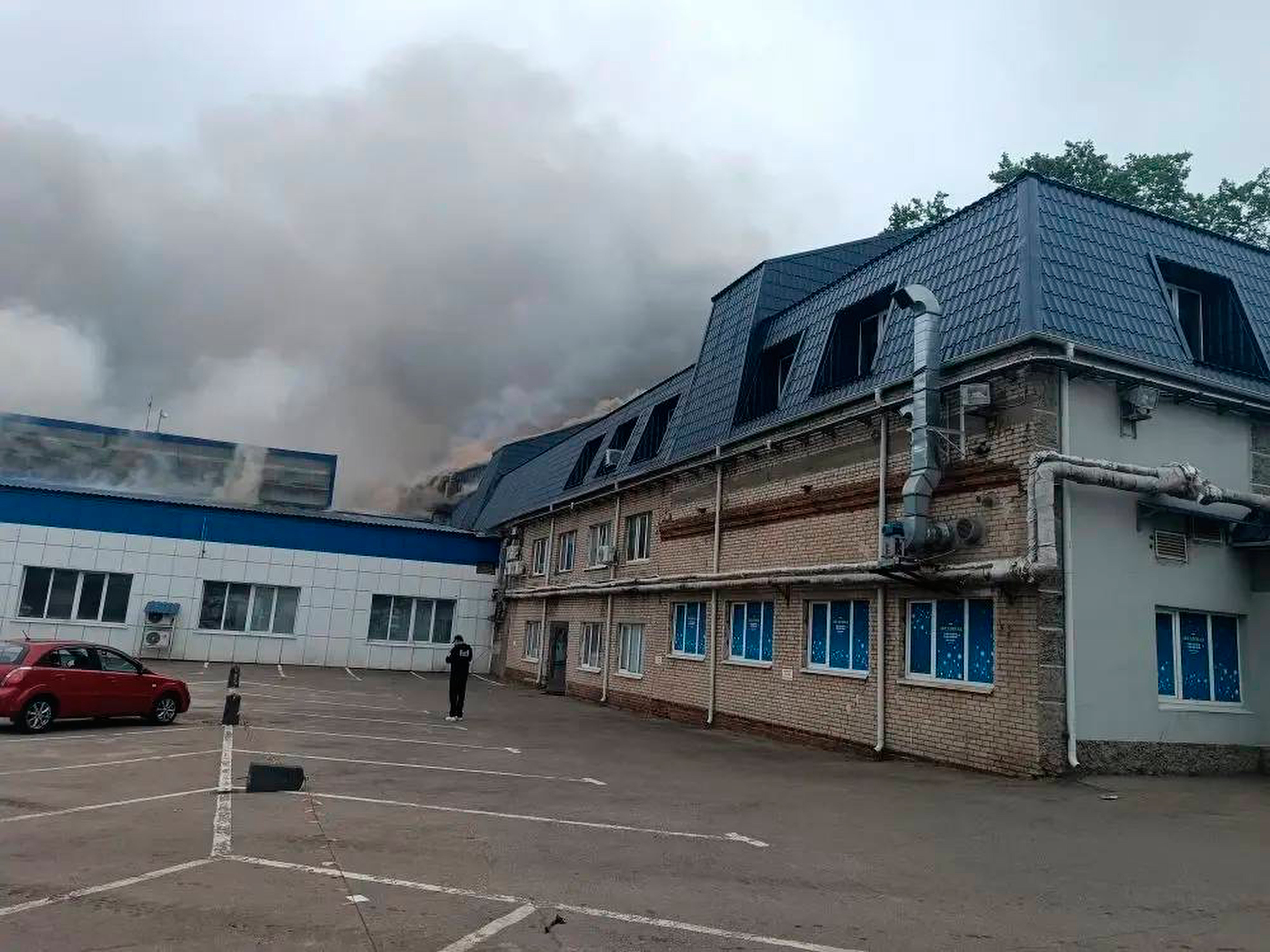 Smoke rises from a damaged building after a Ukrainian drone attack outside Moscow (AP)