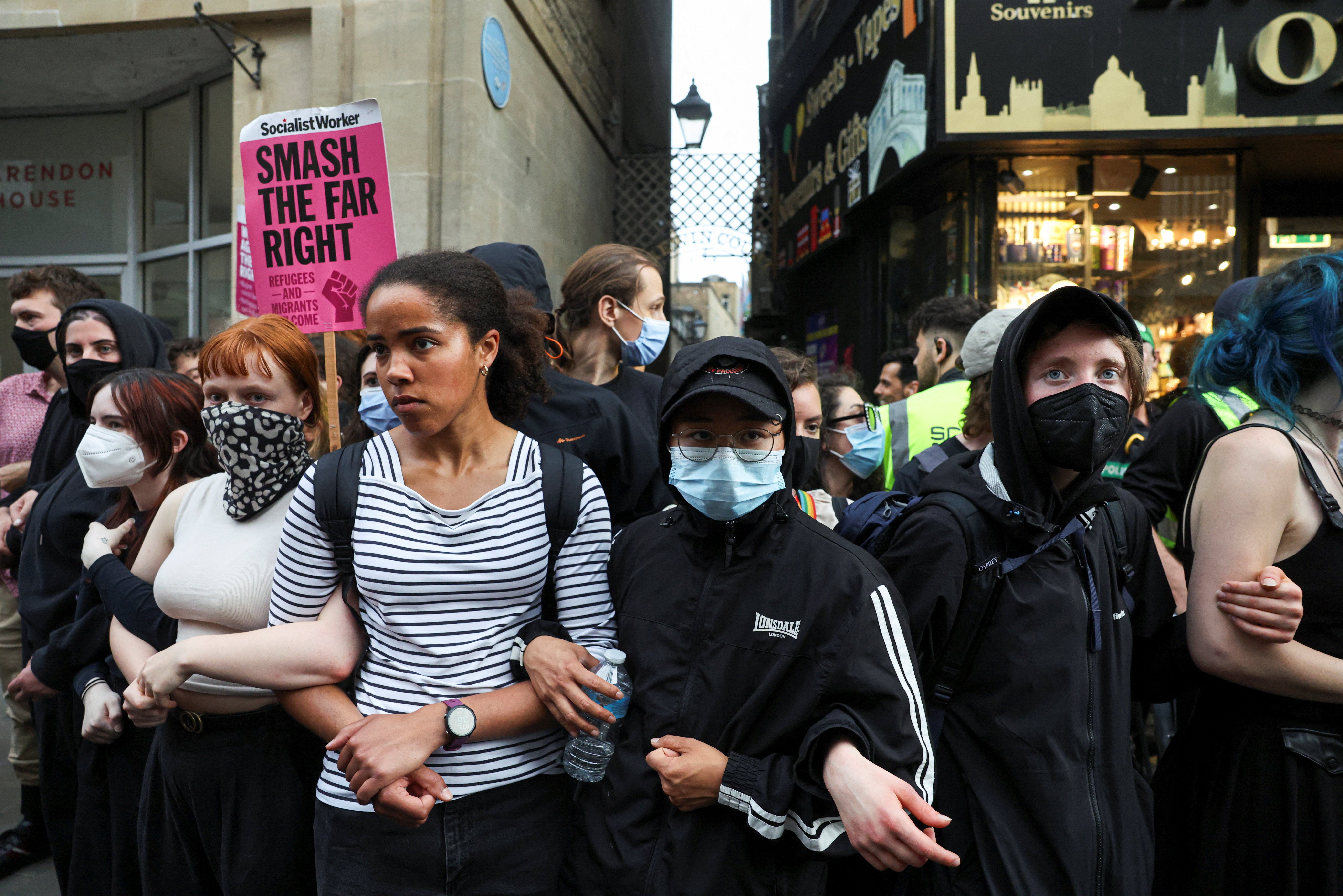Protesters linking arms to block ticketholders from attending