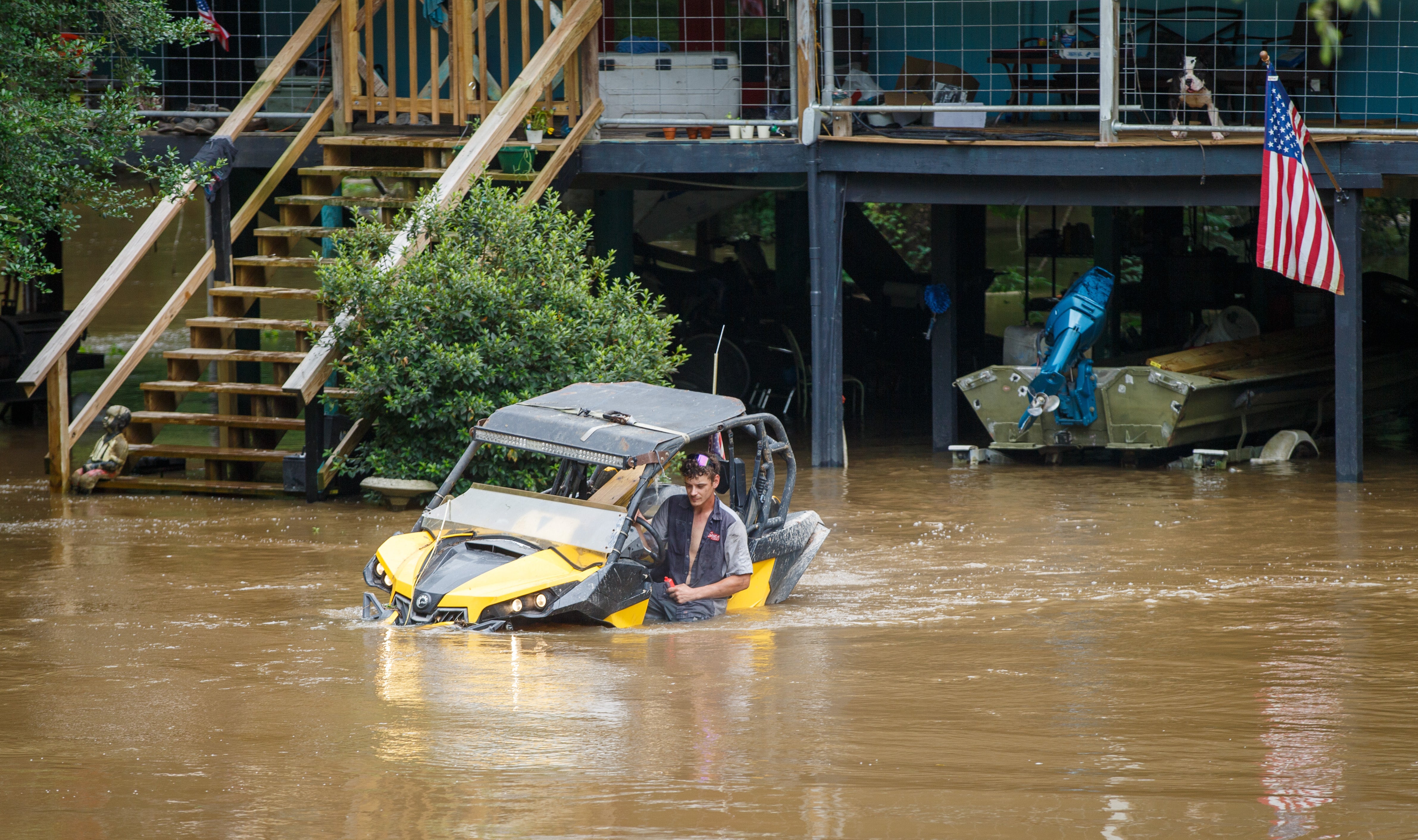 Dalton Saacks moves a mud buggy from the rising Tchefuncte River ahead of Tropical Storm Arthur near Folsom, La