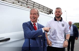 Reform UK leader Nigel Farage reacts next to Reform UK by-election candidate Rob Kenyon as they arrive during the Makerfield by-election