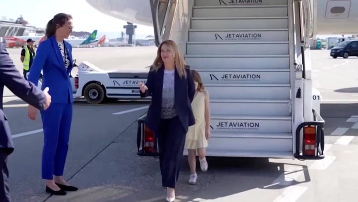 Giorgia Meloni’s camera-shy daughter hides behind mother as pair arrive for G7 summit