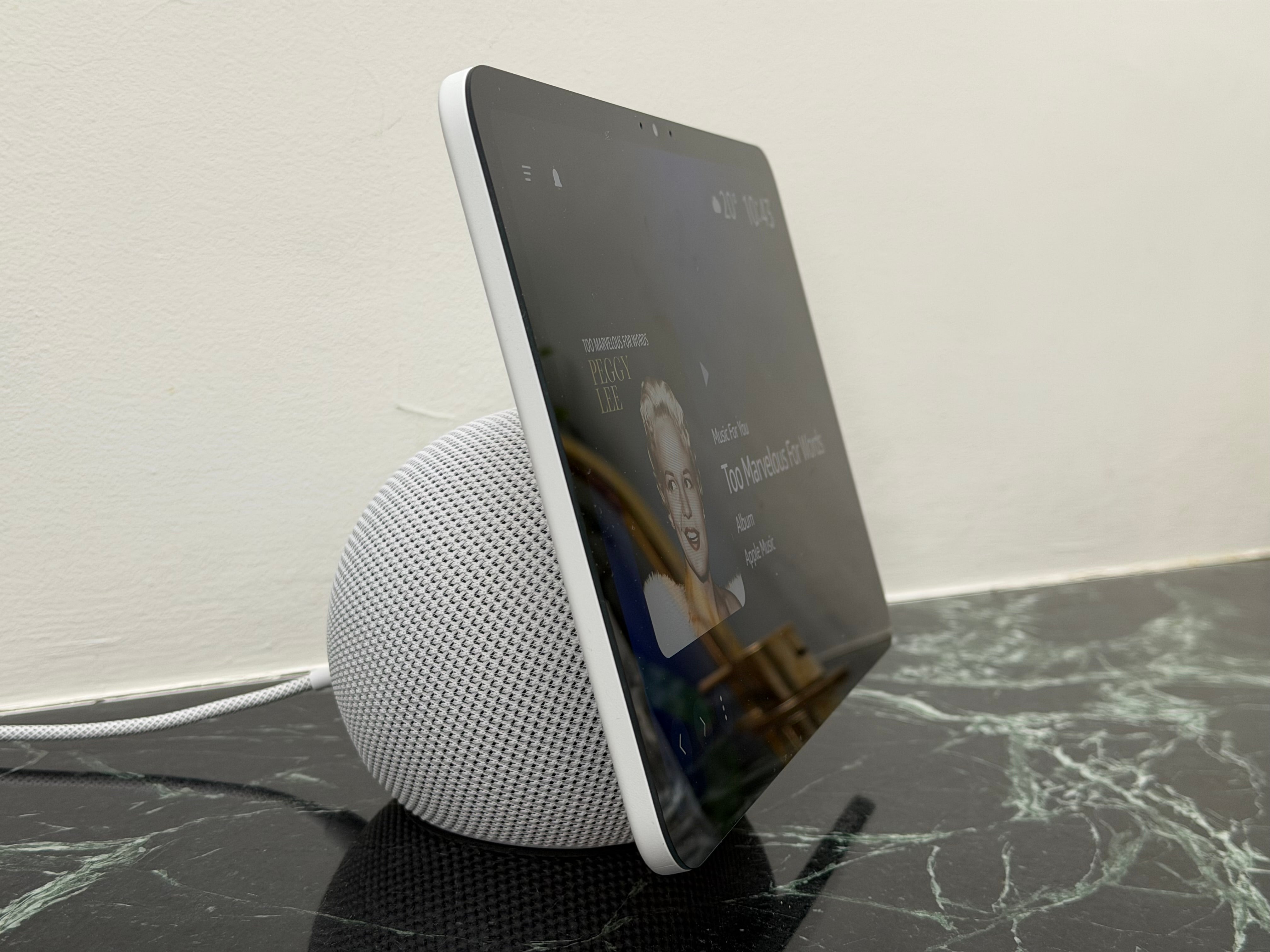 The device features a slim display that appears to float atop the round-edged base (David Phelan/The Independent)