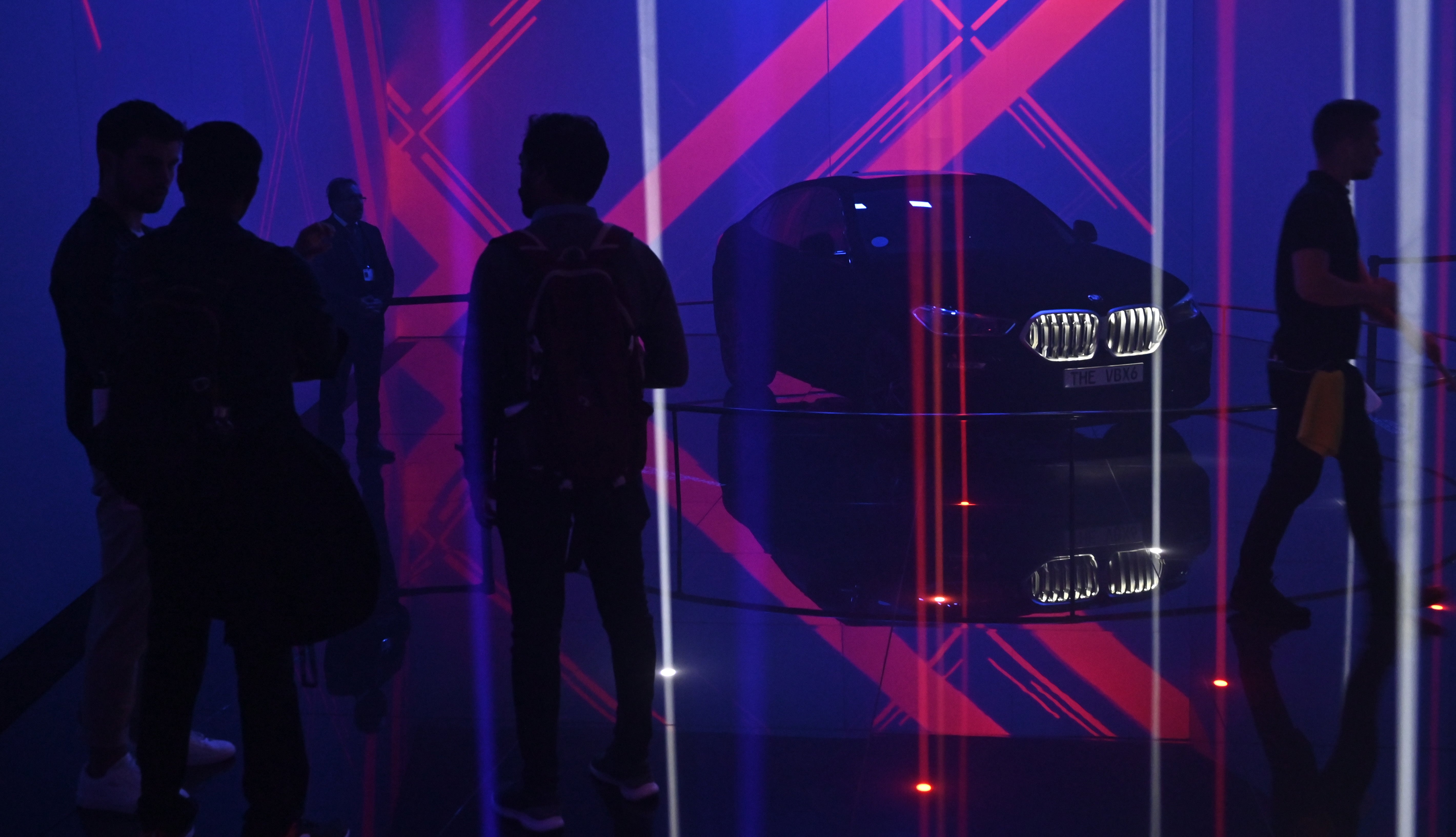 People stand near the BMW X6 Vantablack car during the International Auto Show in Frankfurt, Germany in September 2019. The car had a coating that also absorbed over 99 percent of visible light wavelengths