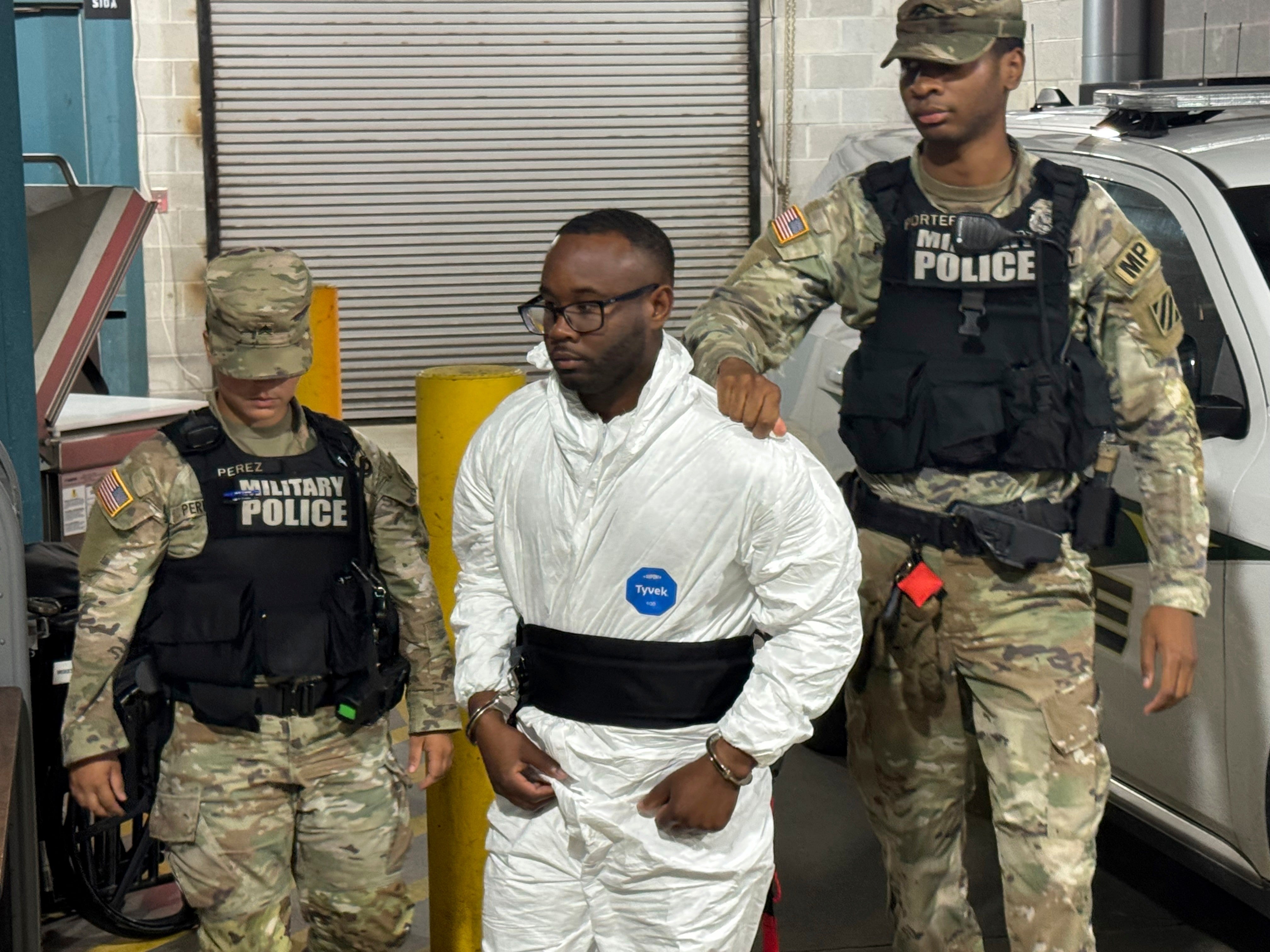Sgt. Quornelius Radford is escorted by military police after his arrest