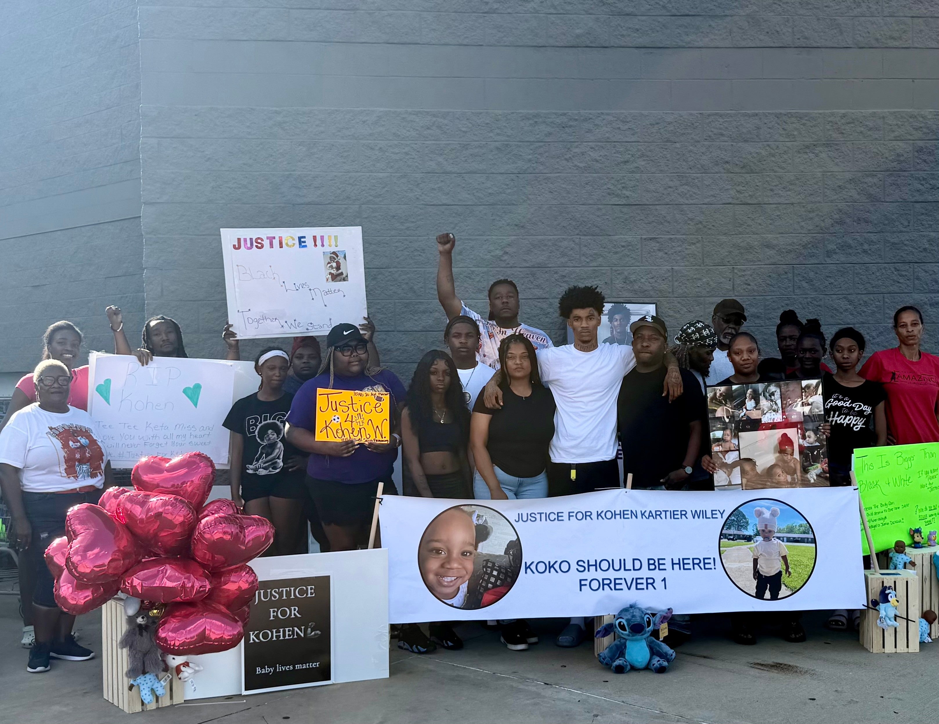 In this photo provided by Marquell Bridges, a group of mourners attend a makeshift memorial for 1-year old Kohen Wiley, outside the Walmart where the boy was shot by police in Senatobia, Miss., on Wednesday, June 17, 2026. (Courtesy Marquell Bridges via AP)