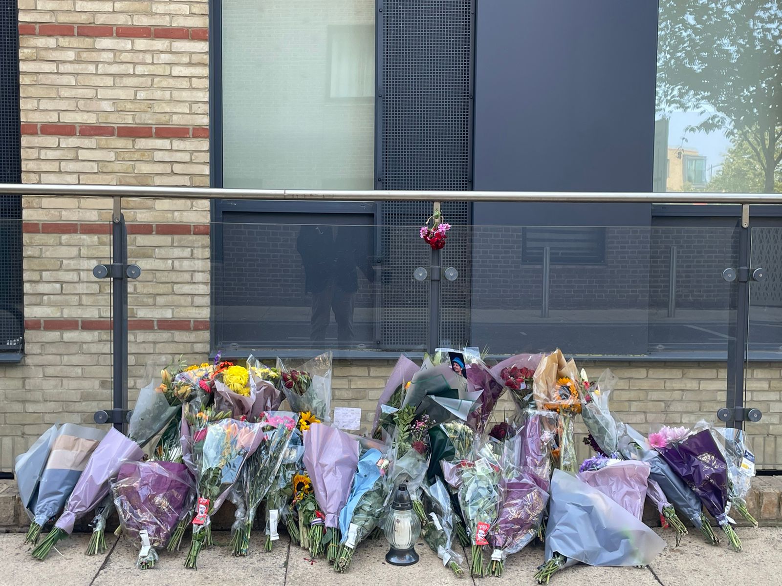 Floral tributes left outside a building in Mill Park in Cambridge where Mohammed Algasim was fatally stabbed