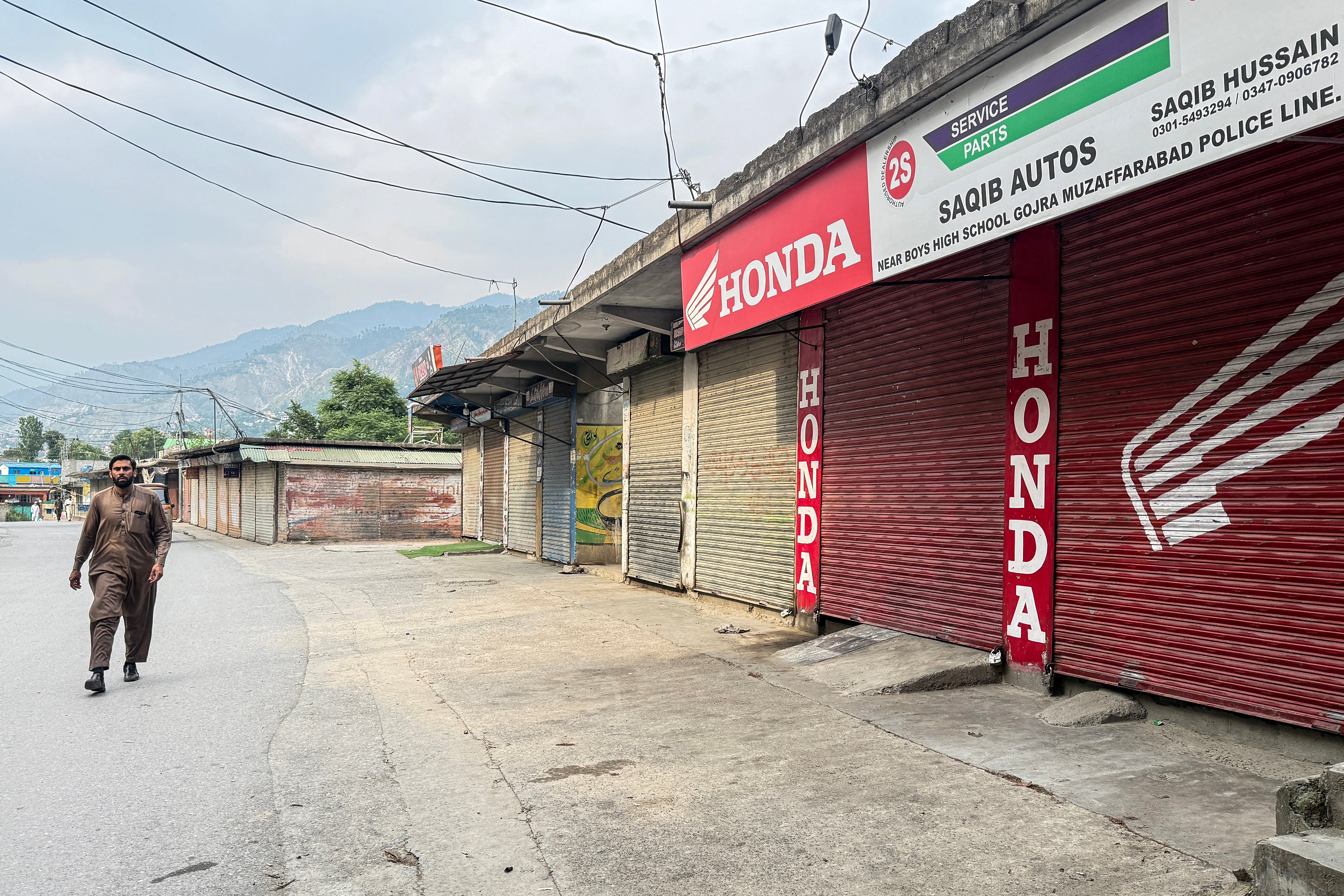 A man walks past a closed marketplace in Muzaffarabad, the capital of Pakistani Kashmir, on 12 June 2026
