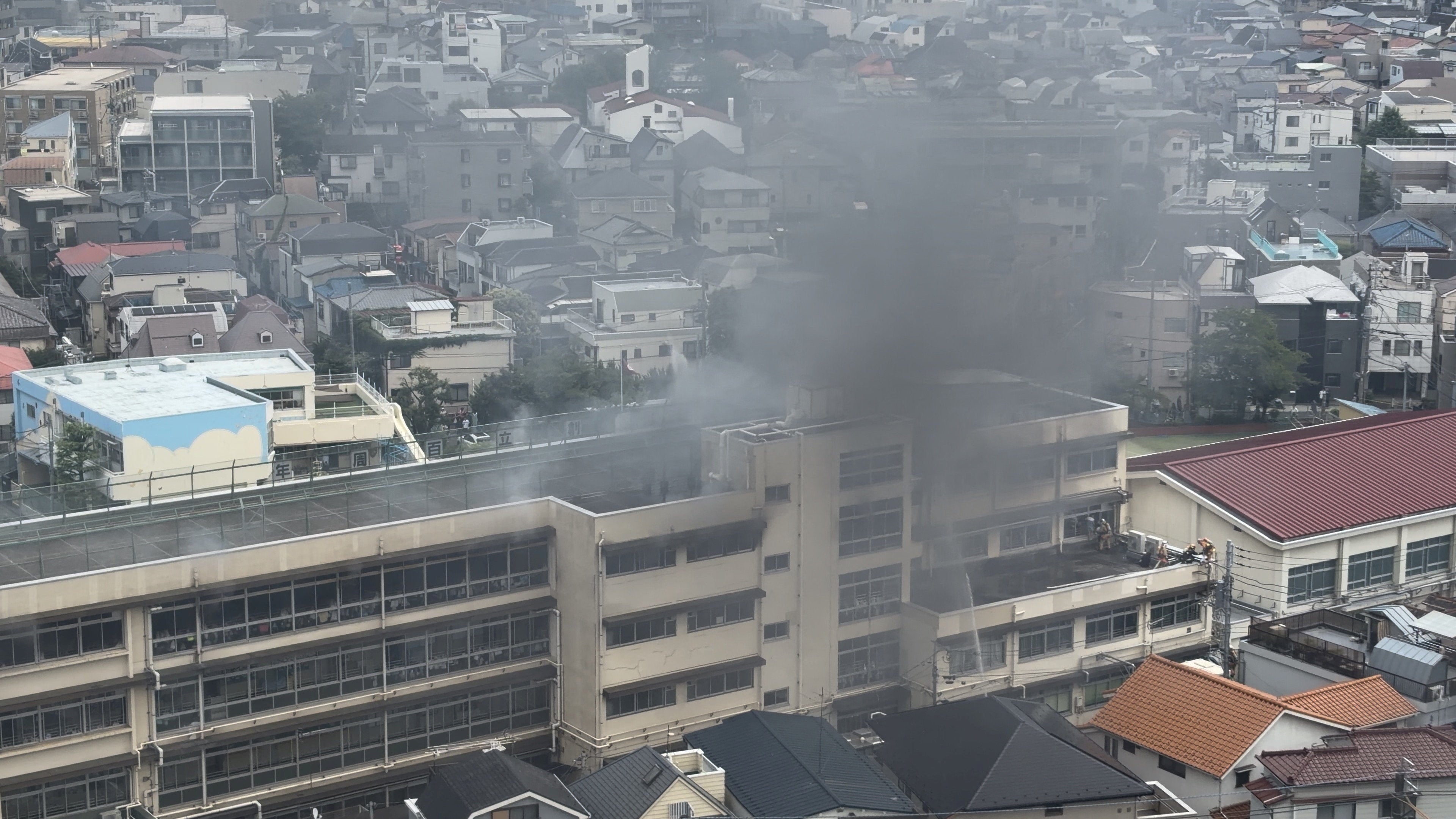 Smoke rises from a primary school after a fire in Kita, Tokyo