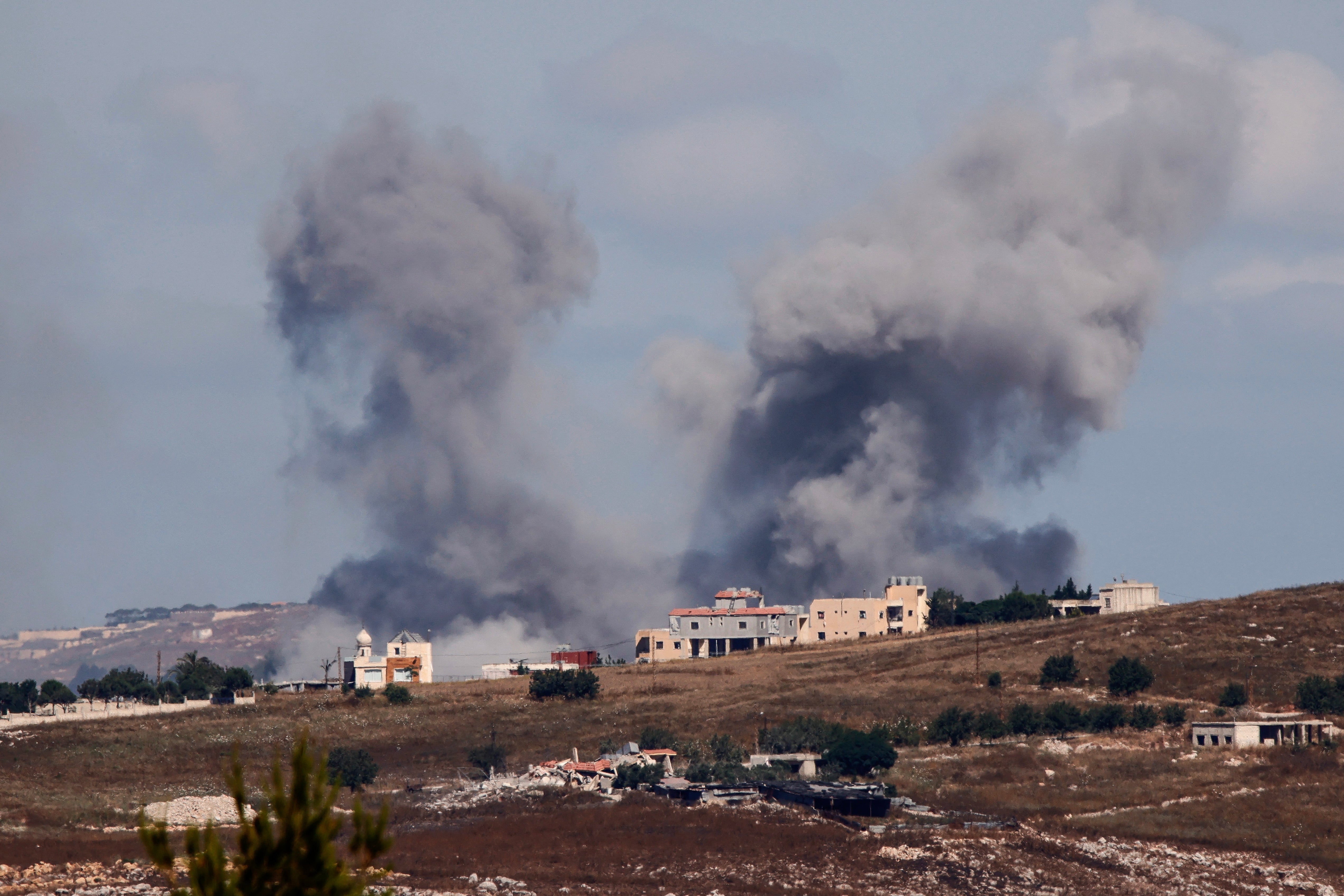 The IDF sharply escalated strikes in Lebanon on Friday following the deaths of four soldiers overnight (pictured: smoke from an Israeli airstrike in Choukine village) (AFP/Getty)