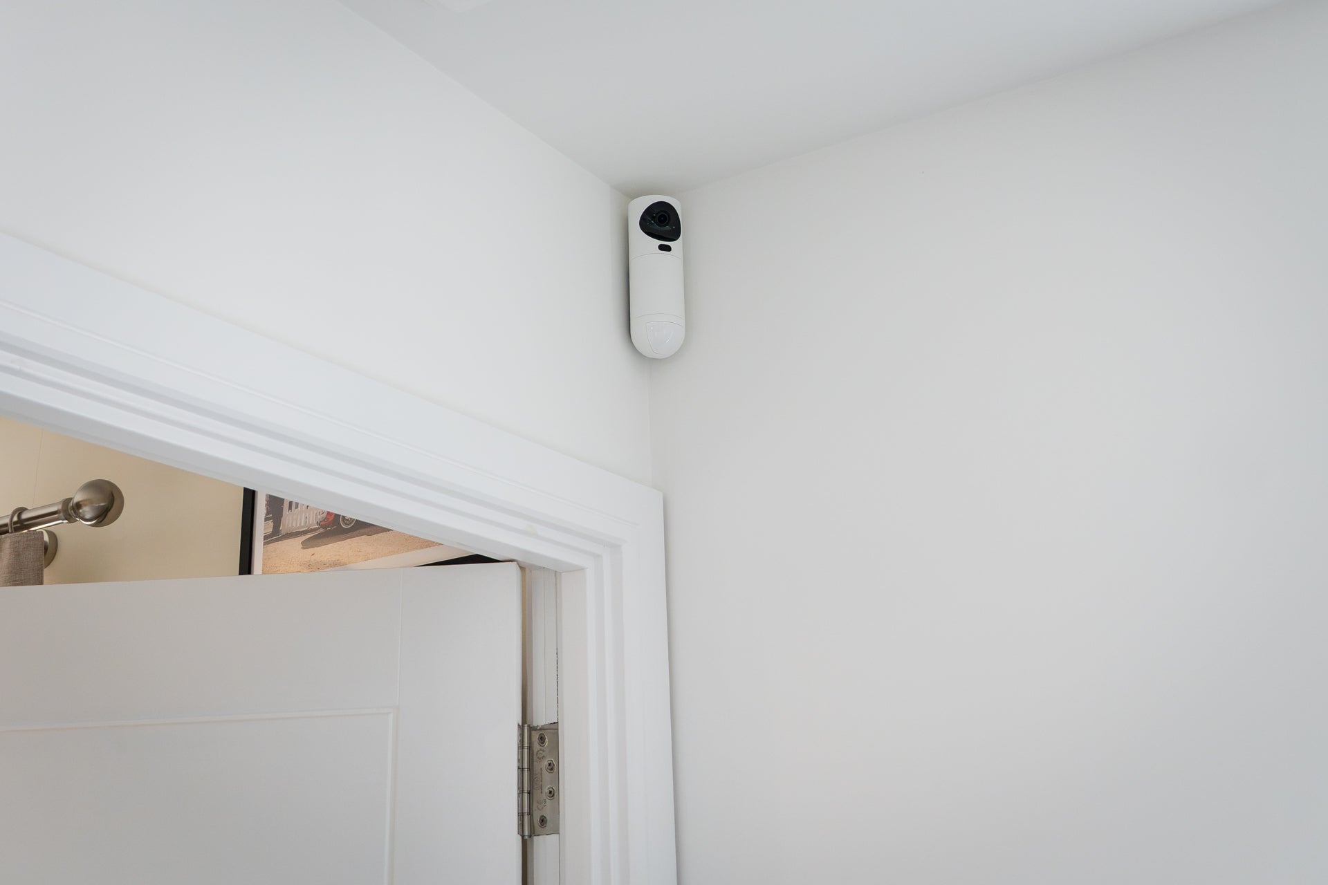 Verisure’s indoor cameras are wireless, mounted high up, and include an integrated motion detector (Alistair Charlton / The Independent)