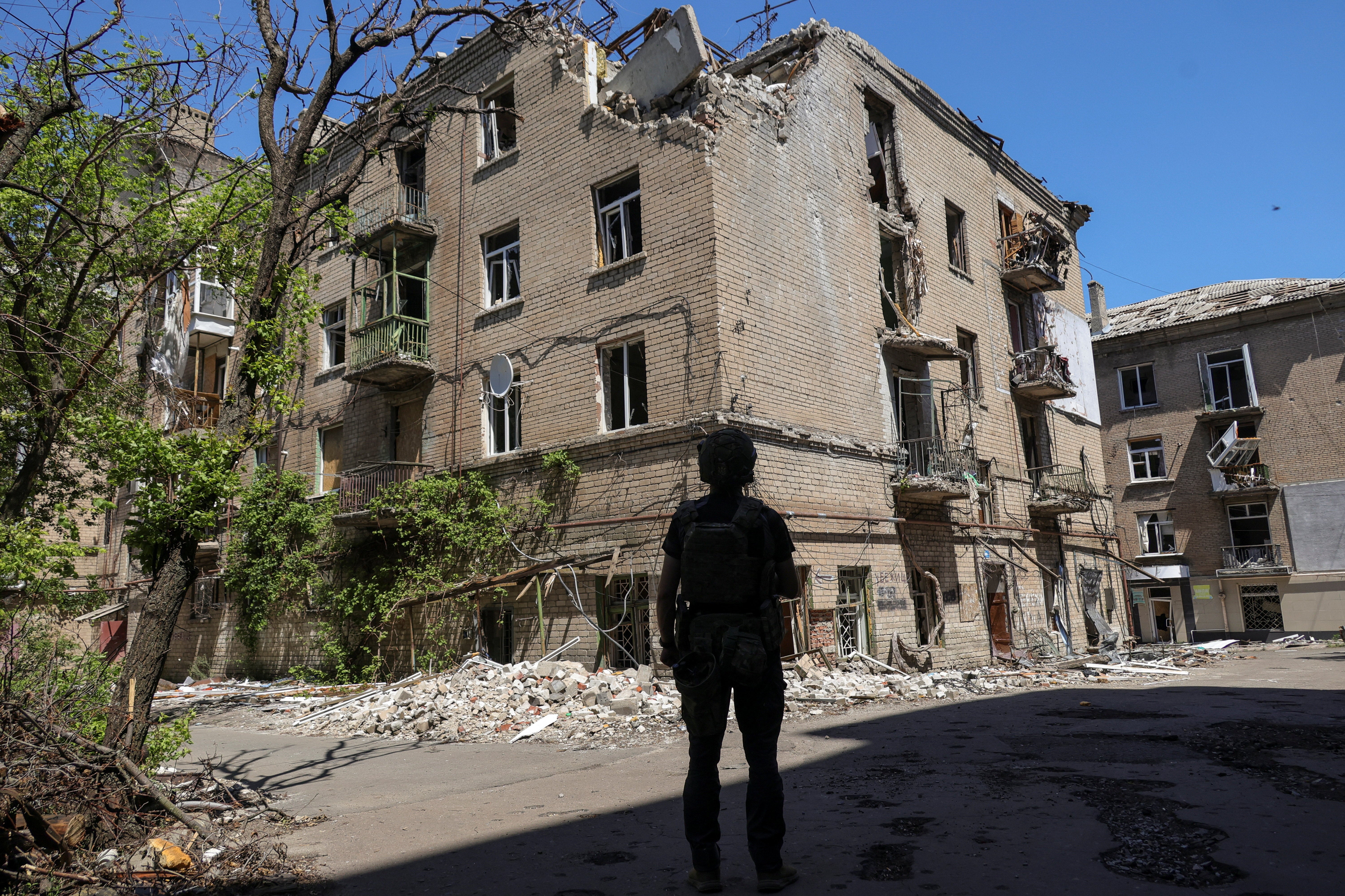 A Ukrainian serviceman looks at an apartment building damaged by Russian military strikes in the frontline city of Druzhkivka, amid Russia's attack on Ukraine, in Donetsk region, Ukraine June 19, 2026. (Reuters)