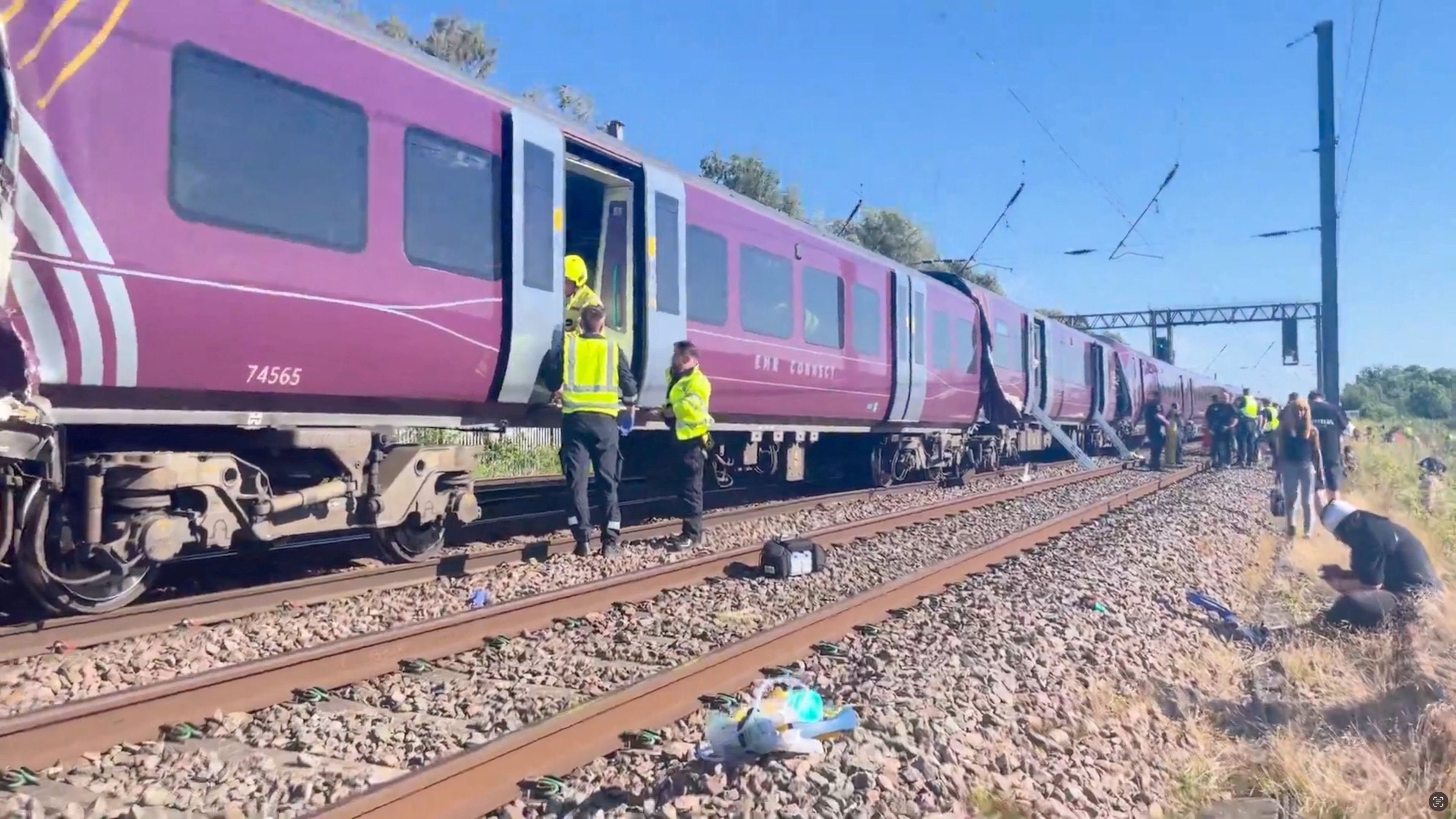 Emergency service workers gather at the scene of a collision involving two trains near Bedford