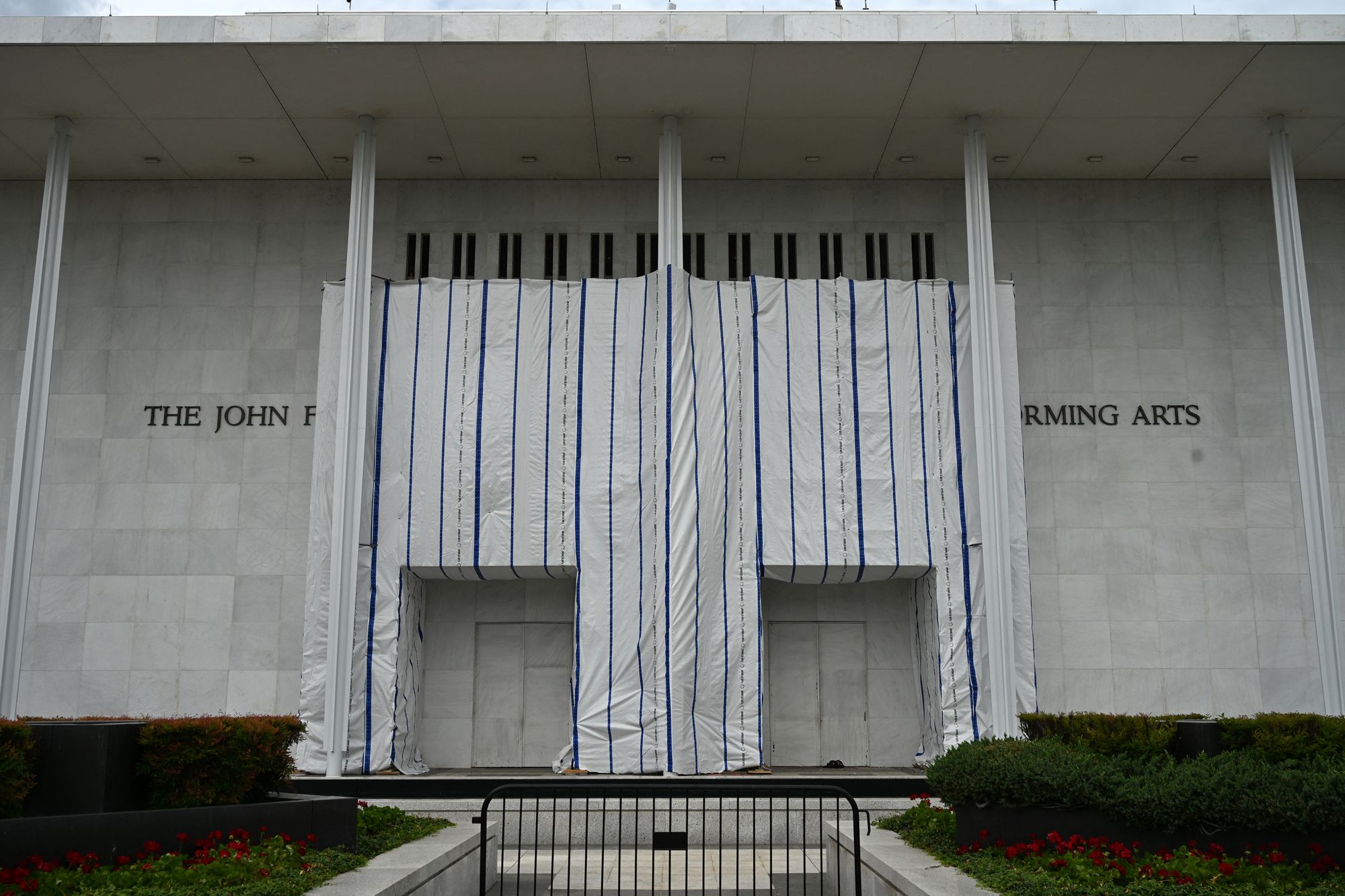 In May, a judge ordered that Trump’s name be removed from the building’s facade. The lettering has since been taken down, but a large tarp remains in place where it once appeared blocking the public’s view of signage (AFP via Getty Images)