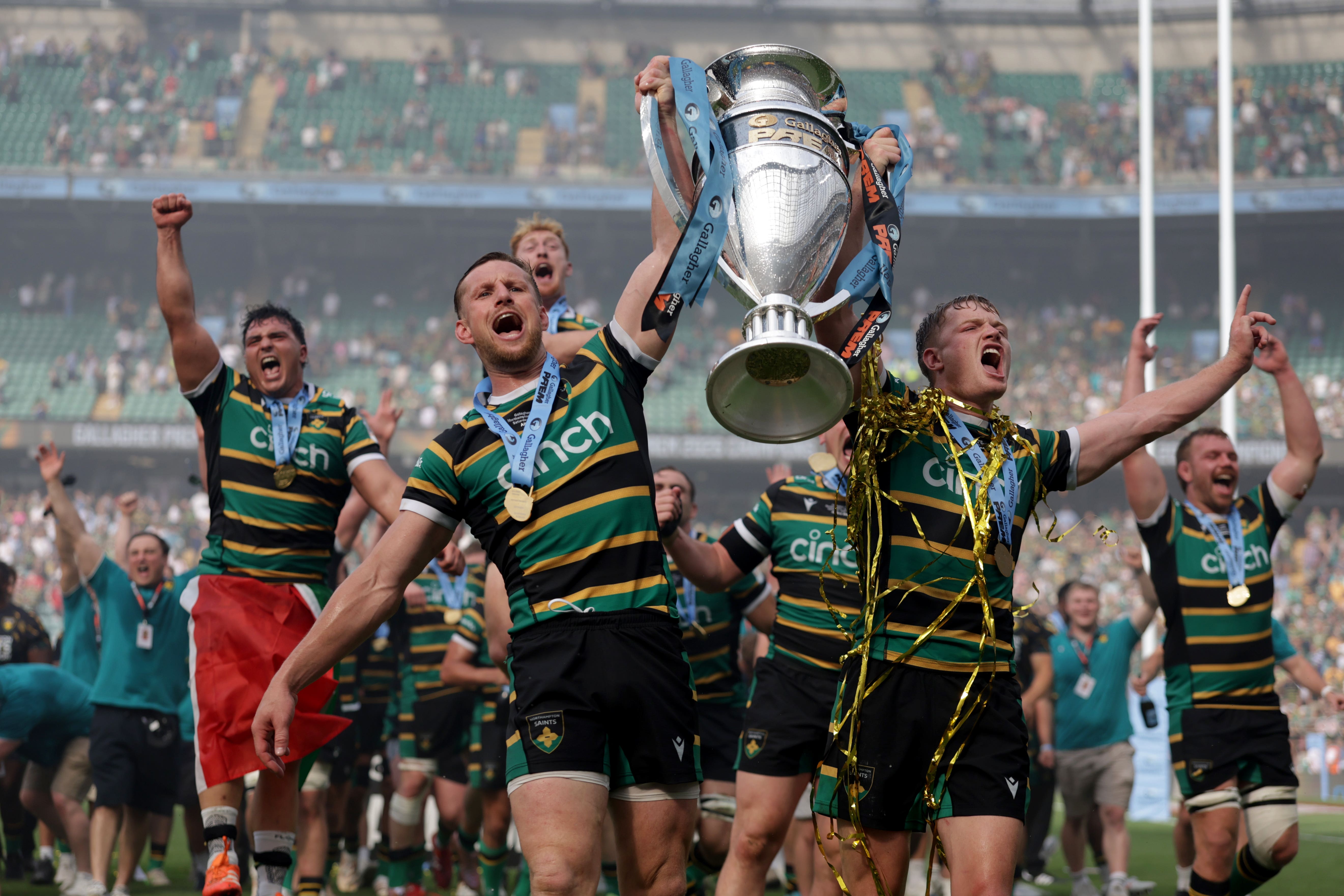 Northampton Saints players celebrate with the Prem trophy (PA Wire)